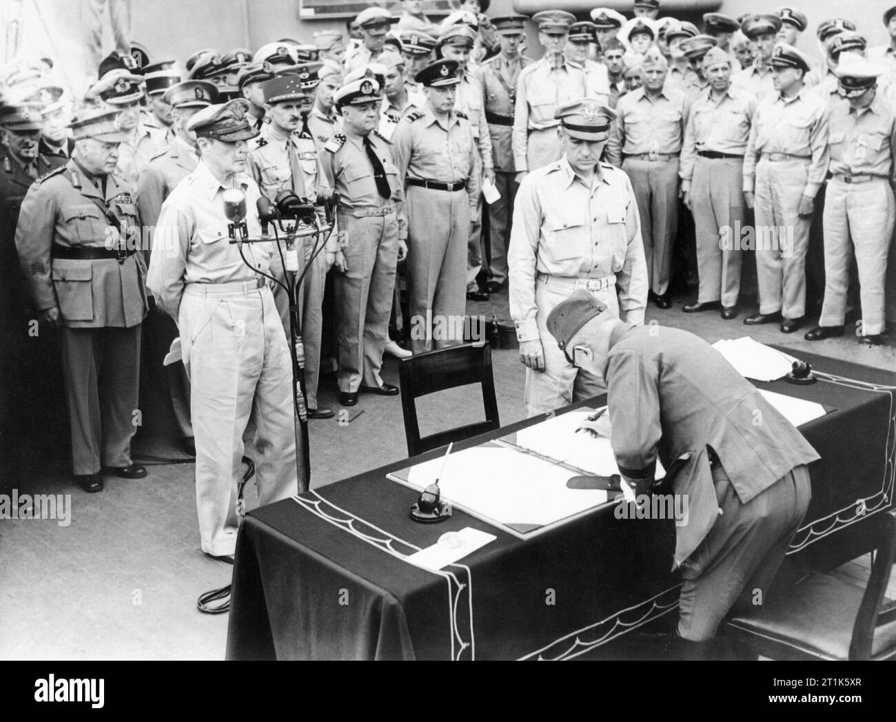 Japanese Surrender at Tokyo Bay, 2 September 1945 General Umezu Yoshijiro signs the surrender on behalf of the Imperial Japanese Army on board USS MISSOURI in Tokyo Bay. Stock Photo