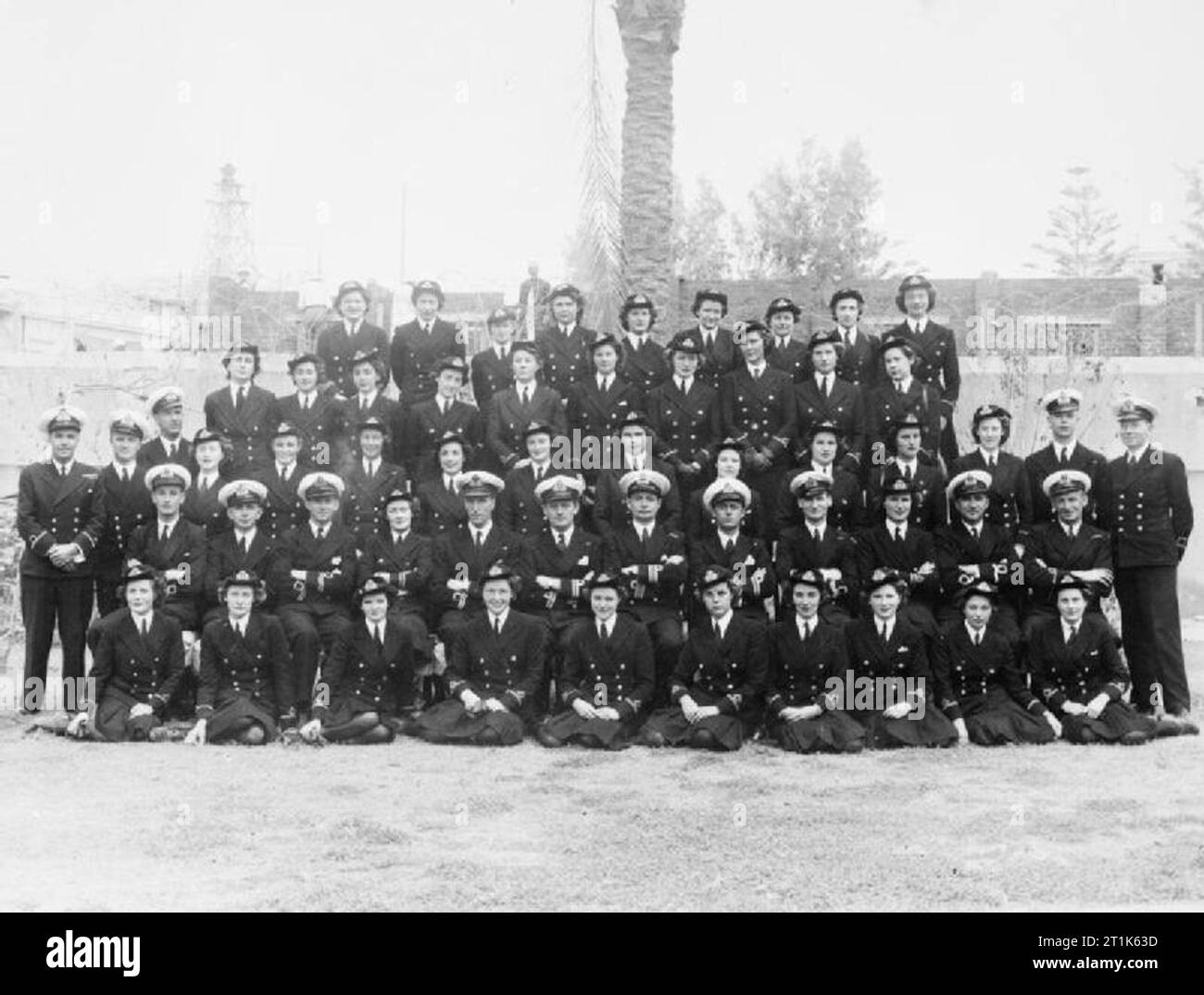 Naval Communications Staff at Alexandria. May 1944, Levant and Eastern Mediterranean Communications Staff. Left to right: Back row: Second Officer WRNS Palmer; Third Officers WRNS: Harrison, Whitelaw, Dilks, McGuire, McKinley. Second Officer WRNS Darrell, Third Officers WRNS: Owen, Clevedon. Fourth row: Third Officers WRNS: Glendinning, Roper, Busby, Hamilton, Seymour, Ward, Hodgson, Beith, Corbett, Patterson. Third row, Mr Porter, Warrant Telegraphist, RN; Sub Lieutenants, RNVR, Trundle, Chapman; Third Officers WRNS, Hind, Courage, Shipley, Foster; Second Officer WRNS Cameron; Third Officers Stock Photo