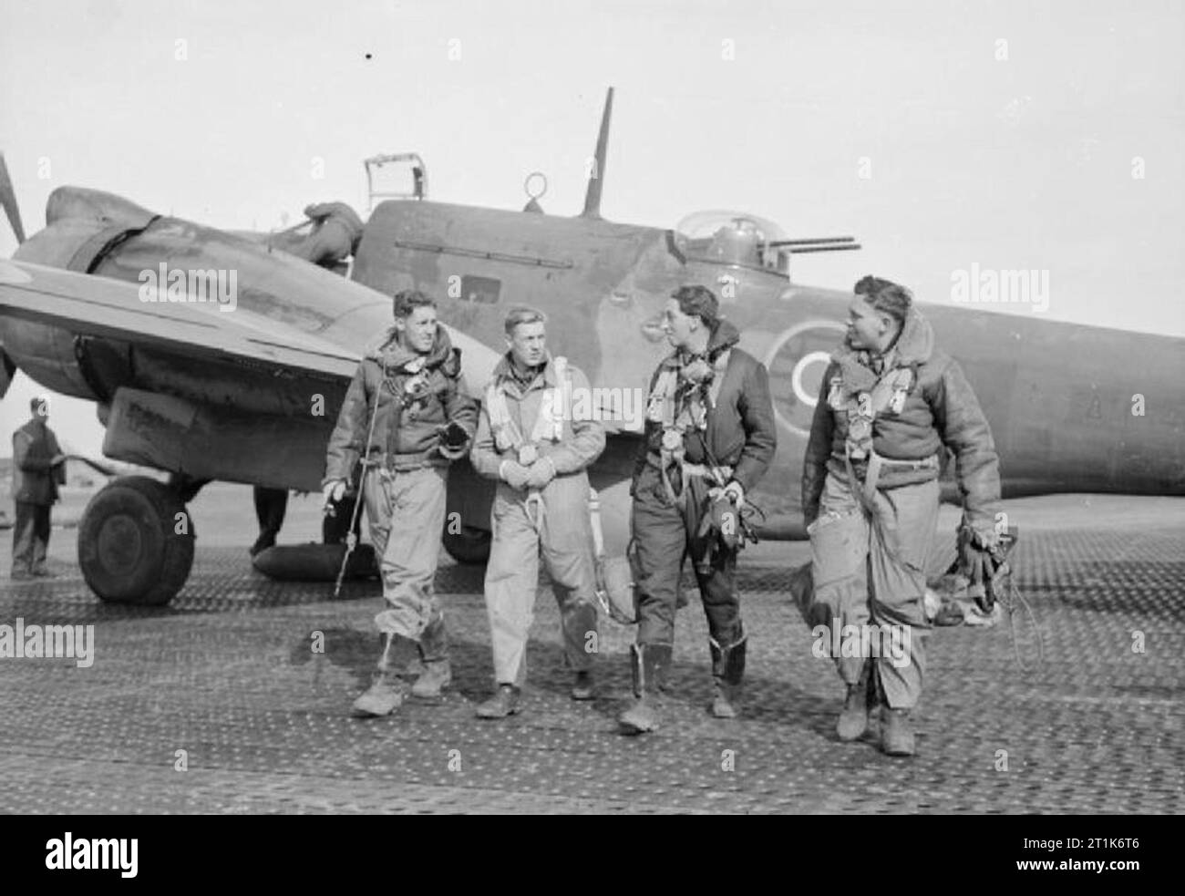Royal Air Force- Italy, the Balkans and South East Europe, 1942-1945. The crew of a Martin Baltimore Mark IV of No. 223 Squadron RAF walk from their aircraft (FA394) at Celone, Italy, after successfully completing a bombing sortie to enemy targets in the Popoli area. They are, (left to right): Sergeant S A Jupp (pilot), of Gravesend, Kent Flight Sergeant W G Gidley (navigator), of Callington, Cornwall Sergeant W A Airth (air gunner), of Hamilton, Lanarkshire Warrant Officer J W Simpson (wireless operator), of Sydney, Australia Stock Photo