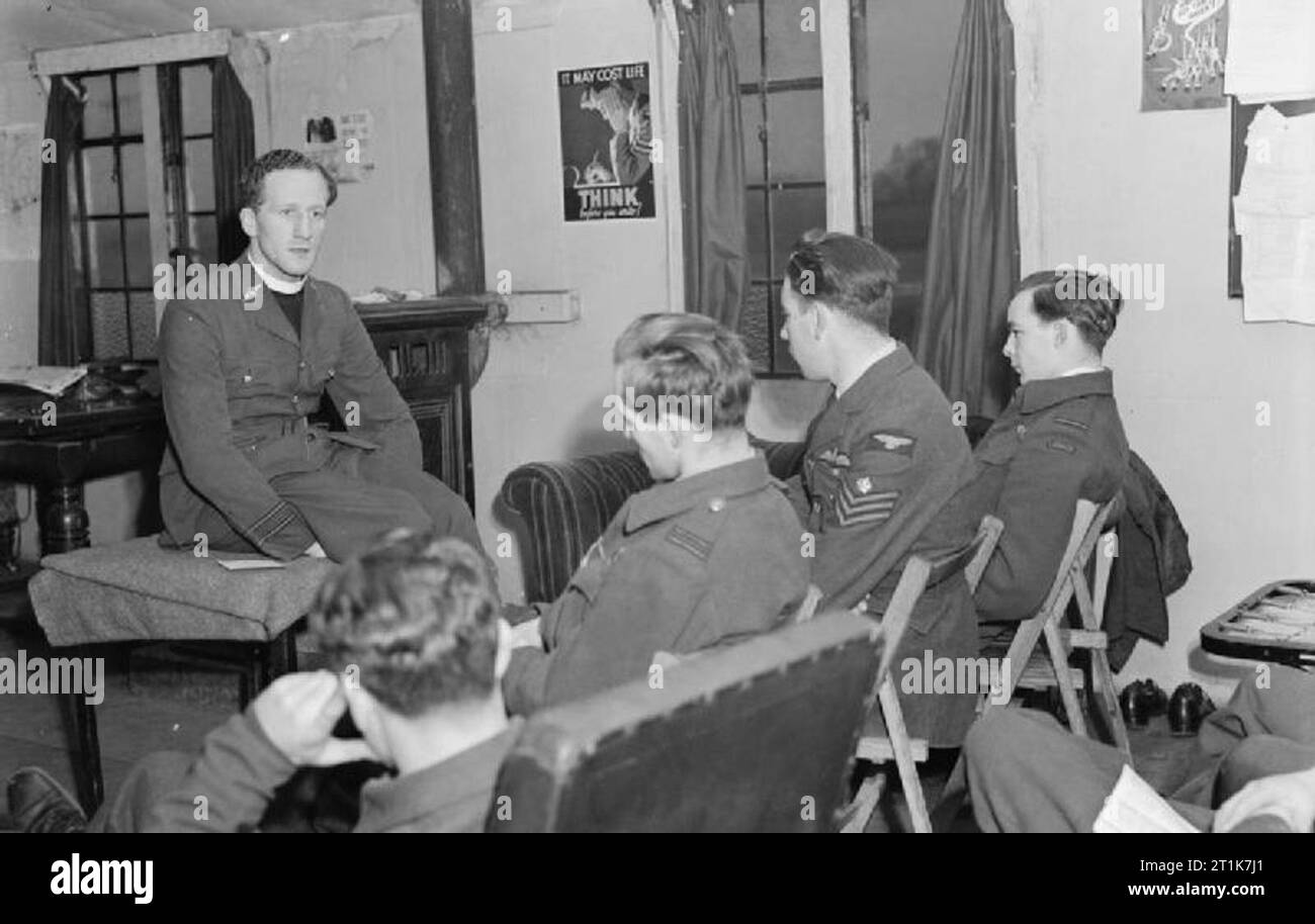Royal Air Force 1939-1945- Fighter Command Squadron Leader The Reverand Hugh Storr conducts Sunday service before a congregation of fighter pilots in a dispersal hut at Tangmere, 10 January 1944. The 29 year-old padre was renowned for his boxing prowess, having previously represented Oxford University as a light-heavyweight. He joined the RAF in the summer of 1943, and soon set about organising - and participating in - a series of inter-station tournaments. Stock Photo