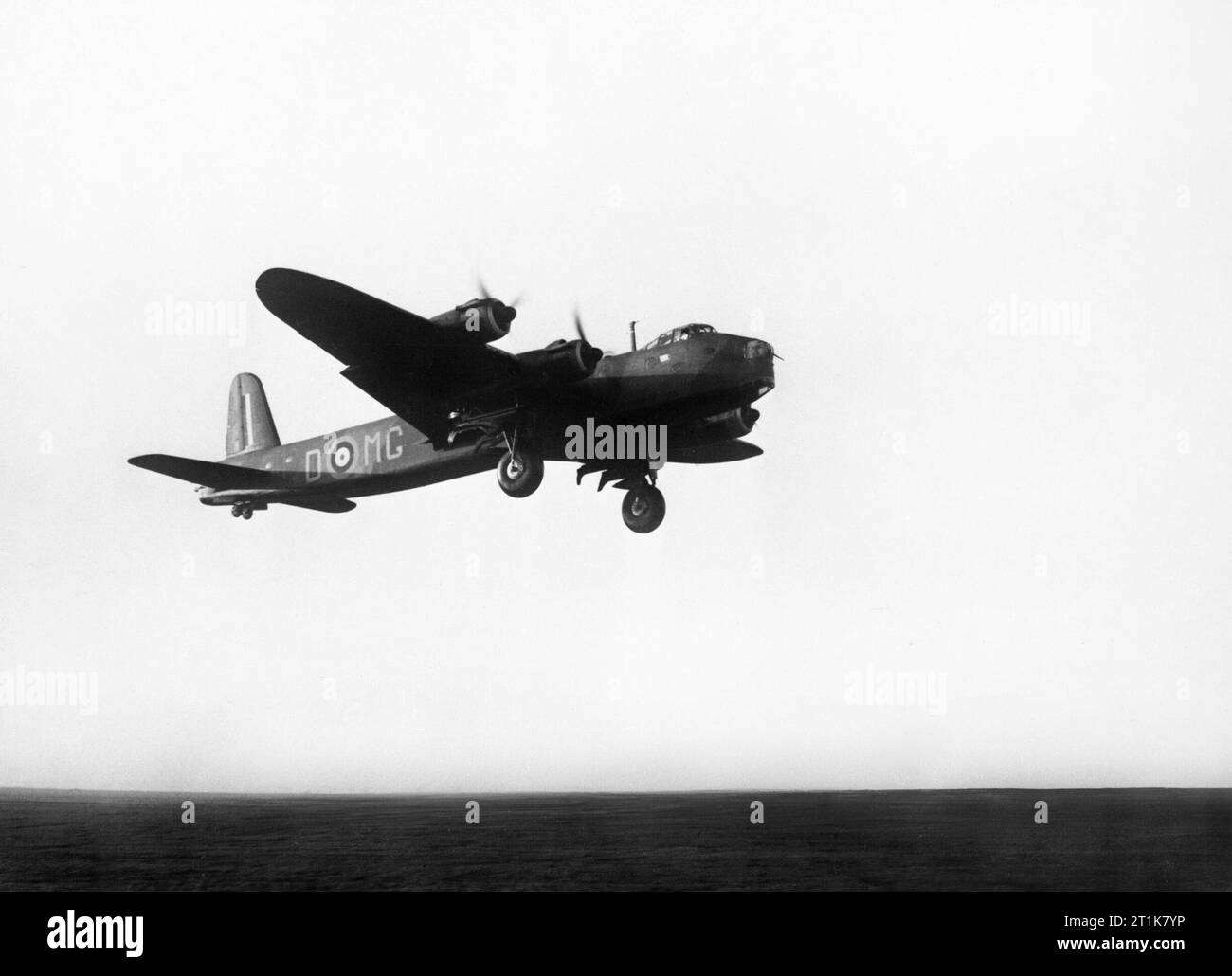 Royal Air Force Bomber Command, 1939-1941. Short Stirling Mark I, N3641 &#145;MG-D&#146;, of No. 7 Squadron RAF taking off at Oakington, Cambridgeshire. 7 Squadron was the first unit to be equipped with the type, which it received in August 1940. N3641 was the seventh production aircraft. Stock Photo