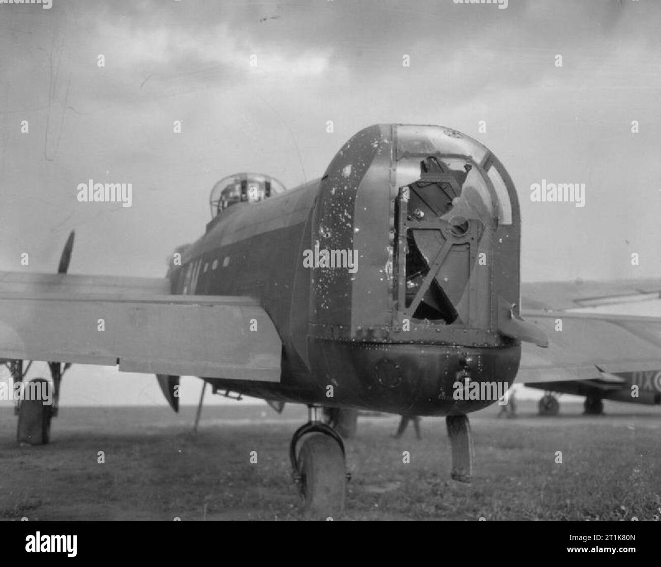 Royal Air Force Bomber Command, 1942-1945. The wrecked rear turret of Avro Lancaster B Mark I, ED413 'DX-M' 'Minnie the Moocher', of No. 57 Squadron RAF at Scampton, Lincolnshire, after returning from a night raid to Oberhausen, Germany, on the night of 14/15 June 1943, during which it was attacked by German night fighters. A cannon shell exploded in the rear turret, killing the gunner, Sergeant R F Haynes of Nuneaton Cheshire, while further strikes smashed the radio and navigational equipment, and riddled the fuselage of the aircraft with holes. The pilot, Sergeant A H Moores of Bromley, Kent Stock Photo