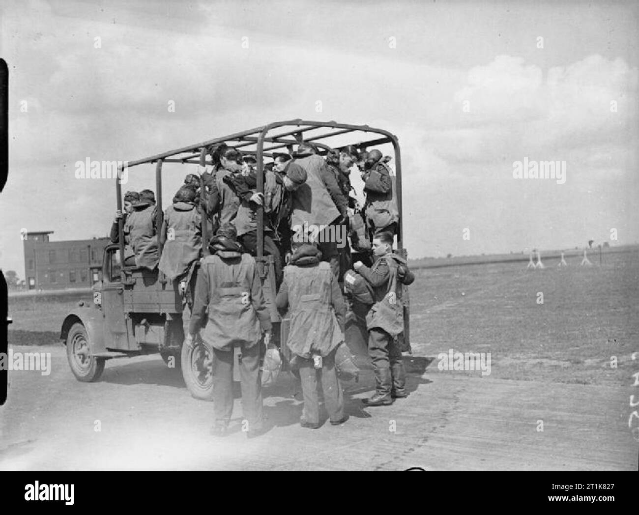 Royal Air Force Bomber Command, 1939-1941. Aircrews of No. 40 Squadron RAF board a lorry for transport to their dispersed Bristol Blenheims at Wyton, Cambridgeshire. They are all wearing the Irvin Harnessuit, a short-legged flying jerkin incorporating a parachute harness and lifejacket bladder, issued to Bomber Command crews from May 1940. Stock Photo