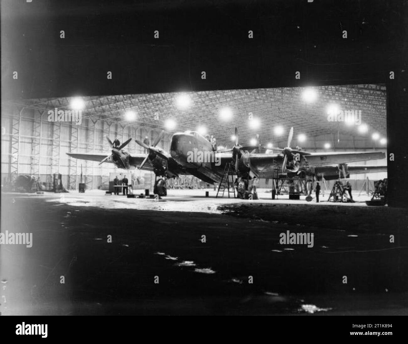 Royal Air Force Bomber Command, 1942-1945. Handley Page Halifax B Mark III Series 1As of No. 1663 Heavy Conversion Unit undergo maintenance at night in a T2 Type hangar at Rufforth, Yorkshire. Stock Photo
