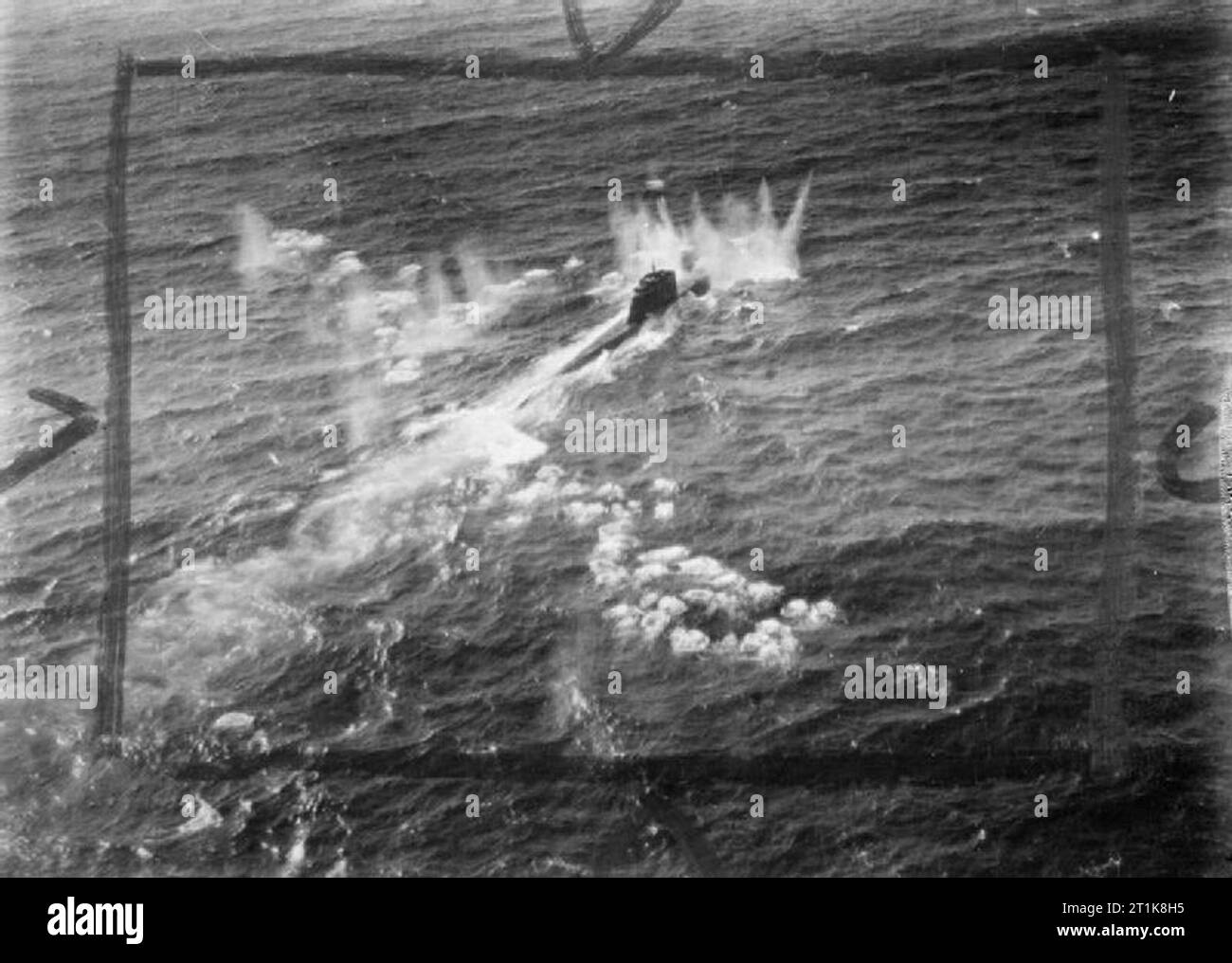 Royal Air Force Coastal Command, 1939-1945. A German type XXI submarine, U-2502, comes under cannon fire from a De Havilland Mosquito FB Mark VI during an attack on four surfaced U-boats and an M-class minsweeper escort in the Kattegat by 22 Mosquitos of the Banff Strike Wing. U-2502 received only slight damage, but a type VIIC submarine was sunk, a type XXIII seriously damaged and the minesweeper left burning. Stock Photo