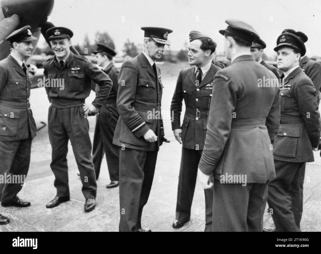 Royal Air Force Fighter Command, 1939-1945. Air Chief Marshal Lord Dowding talking with Group Captain D R S Bader and other veteran fighter pilots before they took off from North Weald, Essex, for the Battle of Britain Anniversary fly-past over London. They are (left to right); Wing Commander J Ellis, Wing Commander T A Vigors, Wing Commander D Crowley-Milling, ACM Lord Dowding, Group Captain D R S Bader, Squadron Leader R Buch, Wing Commander B Drake (partially behind Buch), Wing Commander P M Brothers, and an unknown pilot (behind Brothers). Stock Photo