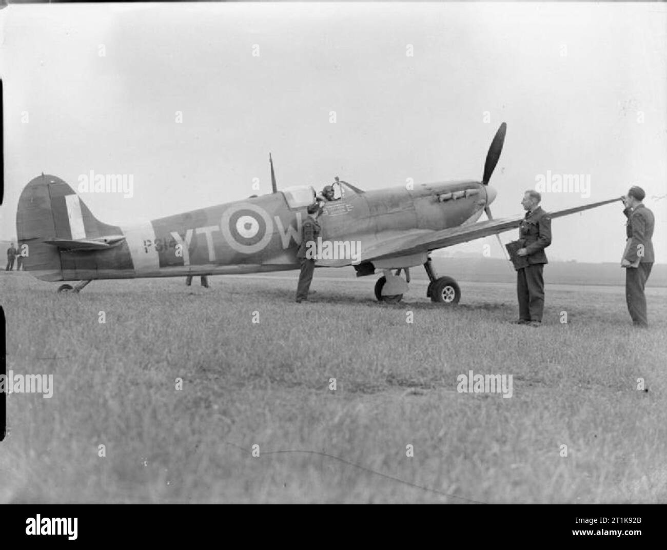 Royal Air Force Fighter Command, 1939-1945. Supermarine Spitfire Mark IIA, P8147 'YT-W' 'City of Norwich', of No. 65 Squadron RAF, attended by groundcrew prior to starting up at Kirton-in-Lindsey, Lincolnshire. After 65 Squadron, P8147 served with a number of units prior to being struck off charge in 1944; these included Nos. 306, 308 and 350 Squadrons, No. 52 Operational Training Unit, No. 5 (Pilots) Advanced Flying Unit, No. 57 Operational Training Unit and finally the Central Gunnery School. Stock Photo