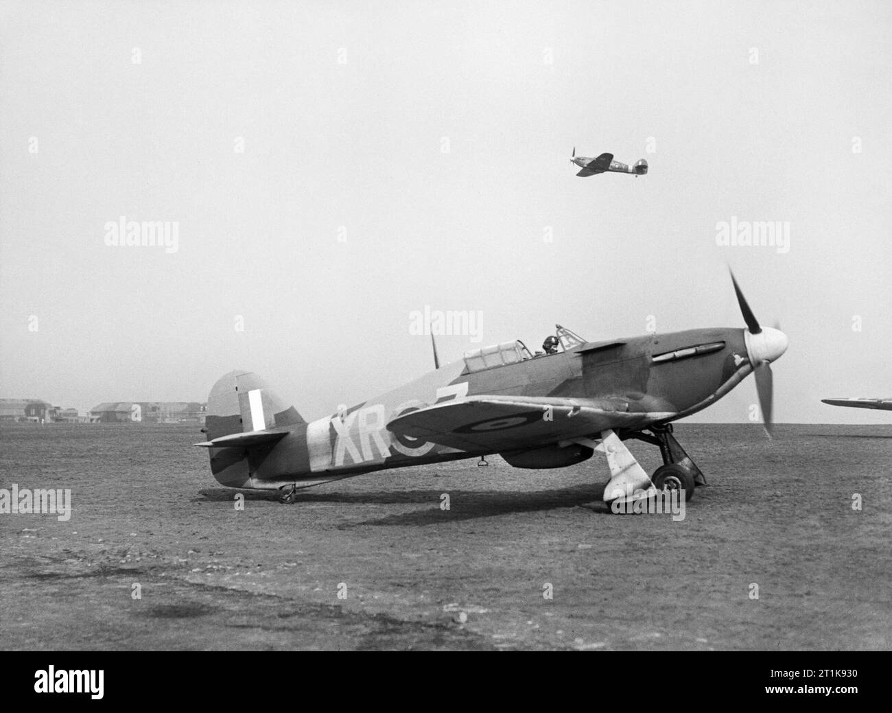 Royal Air Force Fighter Command, 1939-1945. A Hawker Hurricane Mark I of No 71 (Eagle) Squadron takes off from Kirton-in-Lindsey, Lincolnshire, as 'XR-Z', another aircraft of the Squadron, taxies to its take-off point. Stock Photo
