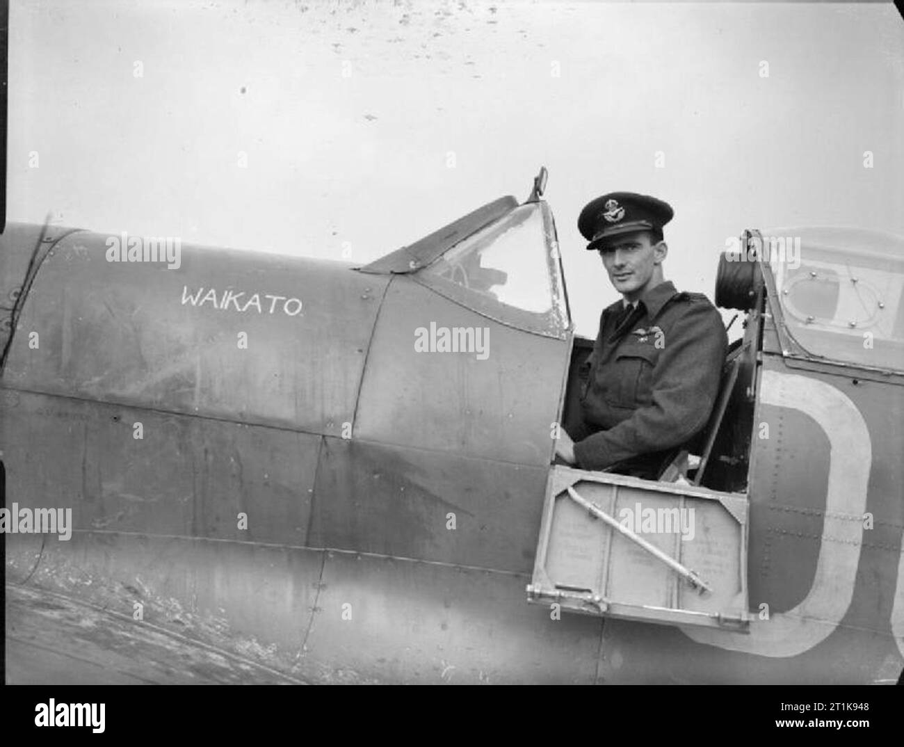 Royal Air Force Fighter Command, 1939-1945. Flight-Lieutenant E P 'Hawkeye'Wells of No 485 (New Zealand) Squadron RAF, sitting in the cockpit of his Supermarine Spitfire Mark VB, 'Waikato', at Kenley, Surrey. He assumed command of the Squadron in February 1942, and later led the Kenley, Tangmere, Detling and West Malling Wings before being appointed the commanding officer of the Fighter Leaders School at the Central Flying Establishment in 1944. He finished the war having shot down 13 enemy aircraft. Stock Photo