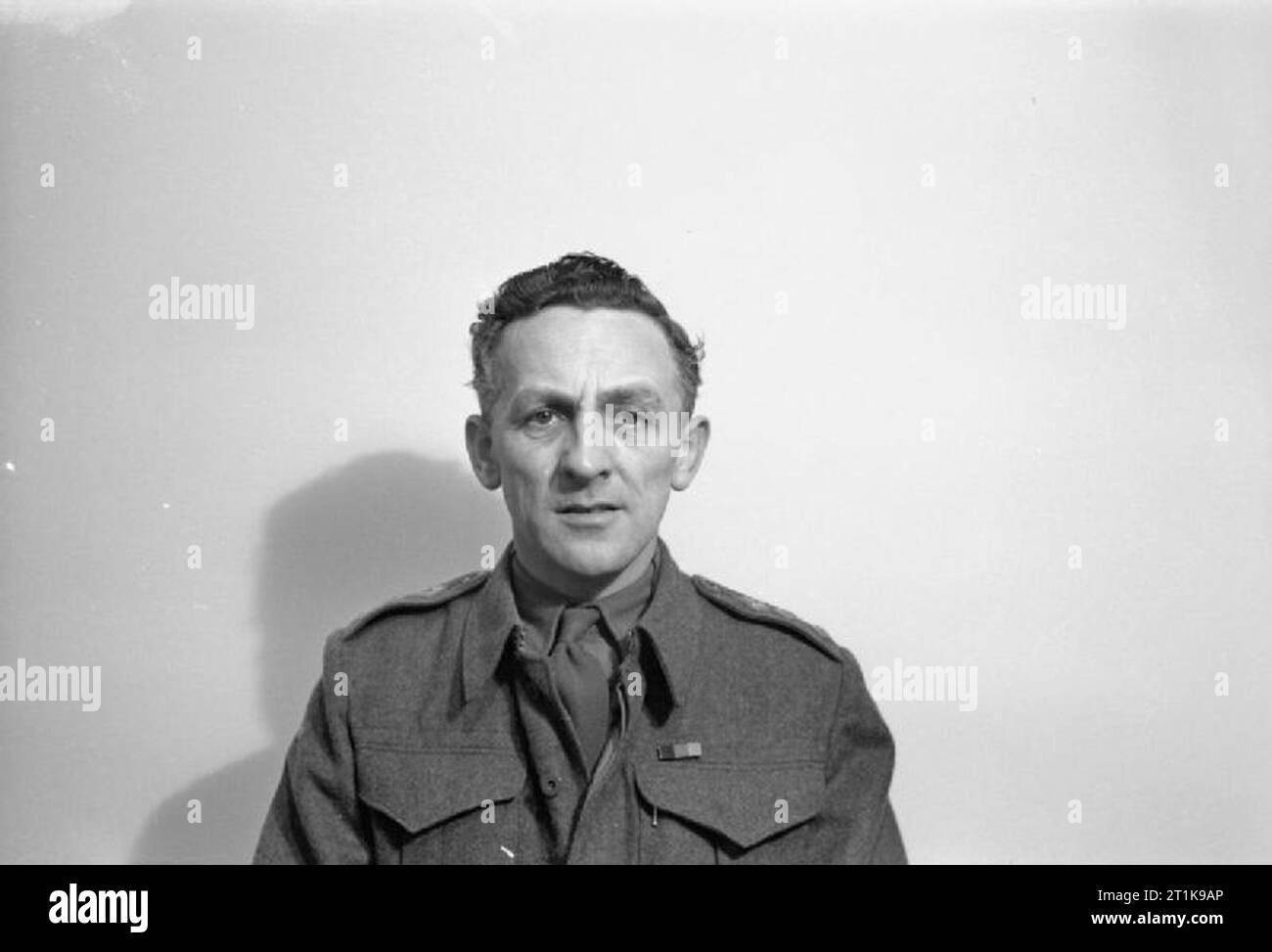 The British Army Film and Photographic Unit 1941 - 1947 Captain E G Malindine, War Office and Army Film and Photographic Unit official photographer shortly after being appointed to 5 Section of the Army Film and Photographic Unit, and tasked with covering the Normandy landings and operations in North West Europe. Captain Malindine served as one of the War Office official photographers in France, Britain and North West Europe from 1940 to 1945. During this time, he photographed numerous key events, including the Dunkirk evacuation in 1940, D Day, the liberation of Paris and Belsen, the German s Stock Photo