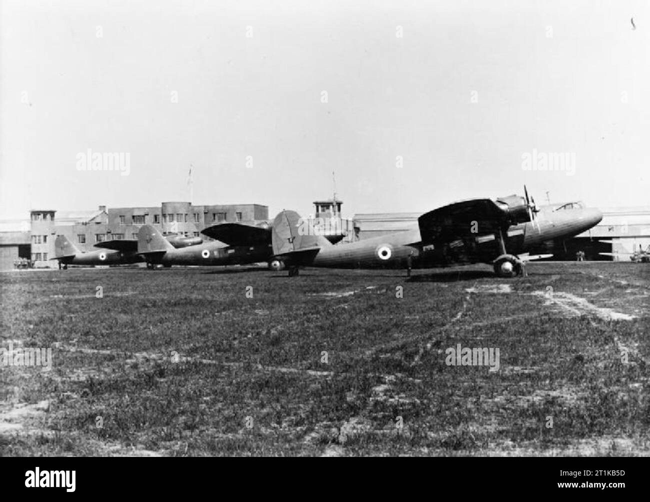 Royal Air Force Training Command, 1939-1940. Fokker F.XXXVI, G-AFZR, and Fokker F.XXIIs, G-AFZP and G-AFXR, of No. 1 Air Observer and Navigation School, parked in front of the airport buildings at Prestwick, Ayrshire. G-AFZR (formerly PH-AJA) was purchased from the Dutch airline KLM by the RAF in 1939. It was flown and maintained by Scottish Aviation Ltd, Prestwick, under its civil registration, and served alongside the F.XXIIs as a navigational trainer, initially with No. 12 Elementary Flying Training School, followed by 1 AONS. On 21 May 1940, G-AFZR crashed on take off from Prestwick. Stock Photo