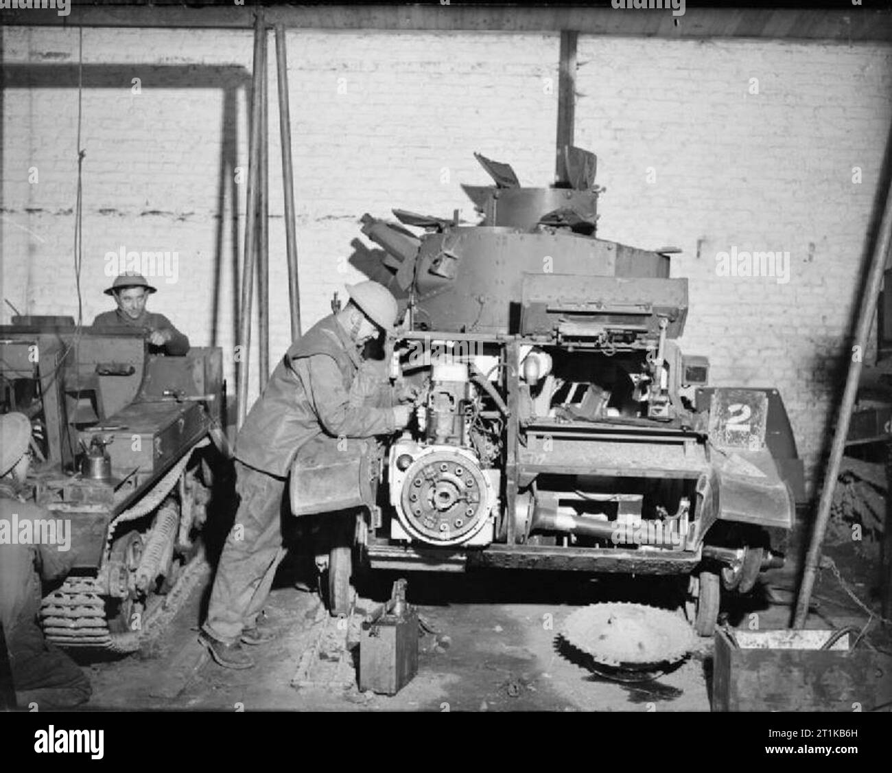 The British Army in France 1939-40 A Light Tank Mk VI undergoes repair work on its engine at a RASC vehicle workshop, 3 January 1940. Stock Photo