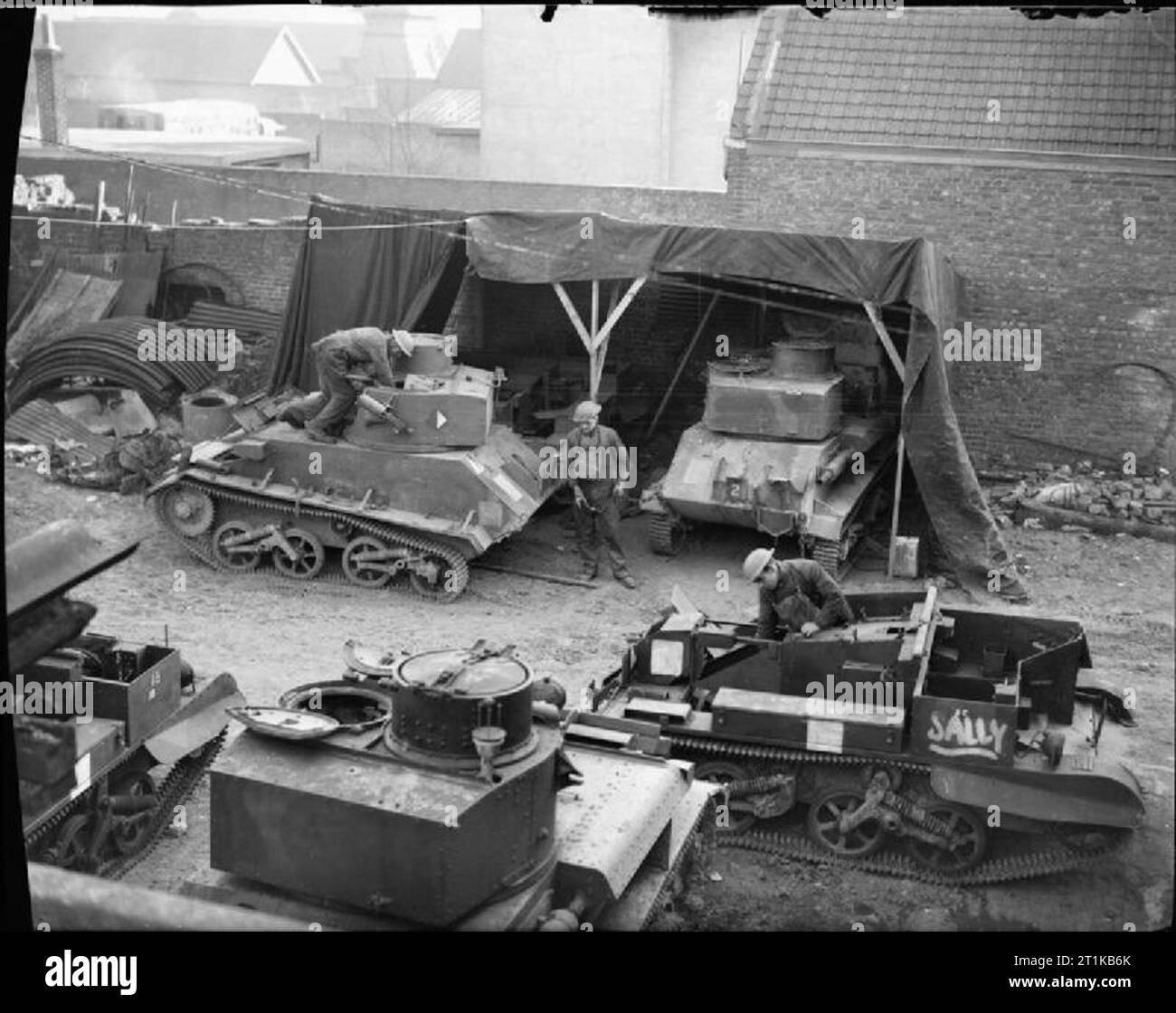 The British Army in France 1939-40 Light Tank Mk VIs and Bren gun carriers undergoing repair work at a RASC vehicle workshop, 3 January 1940. Stock Photo