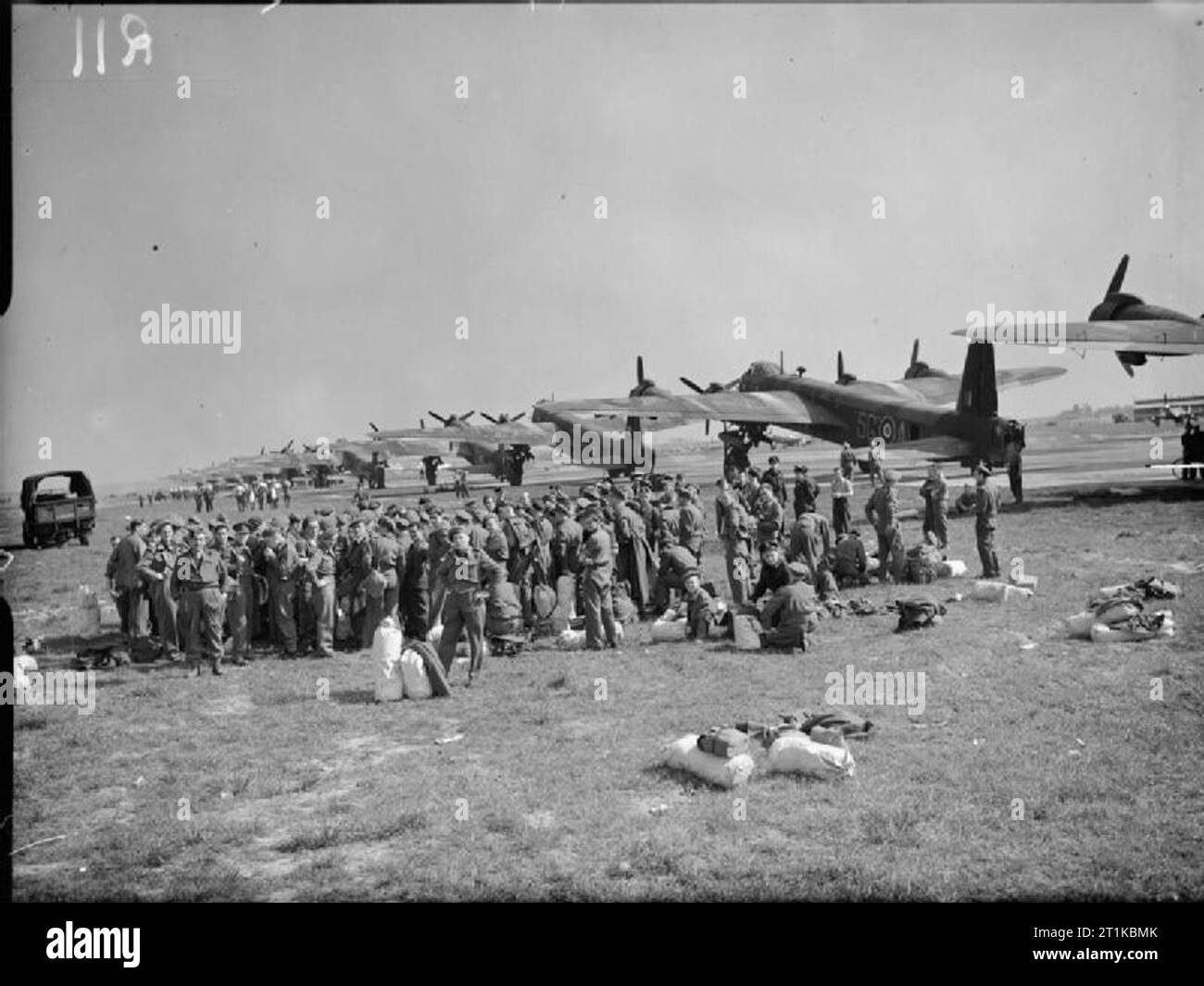 Royal Air Force- Fighter Command, No. 38 (airborne Forces) Group RAF. Liberated Allied prisoners-of-war wait on an airfield in Belgium before boarding a line of Short Stirlings (those in the foreground belonging to No. 299 Squadron RAF) for repatriation to the United Kingdom. Stock Photo