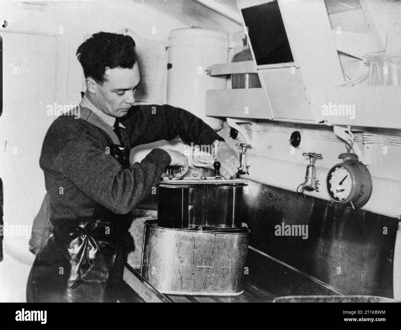 Royal Air Force- France, 1939-1940. A photographer removes developed aerial reconnaissance film (taken by an F.24 aerial camera) from a developing tank in a Mobile Darkrooms tender at the Headquarters of No. 71 Wing RAF, Bétheniville. Stock Photo