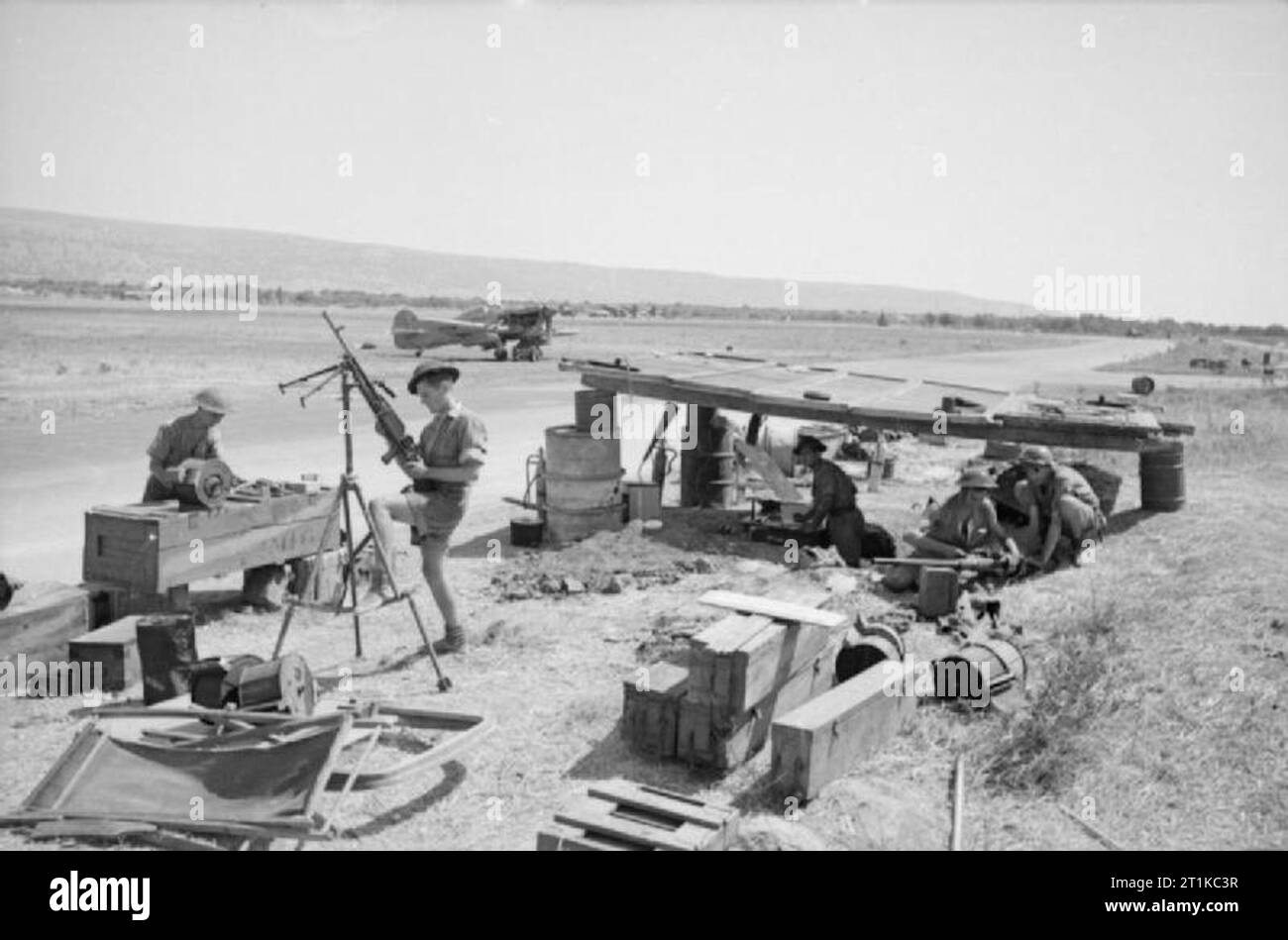 Royal Air Force- Italy, the Balkans and South-east Europe, 1942-1945. Armourers of No. 3201 Servicing Commando work from improvised cover by the perimeter track at Comiso, Sicily. Stock Photo
