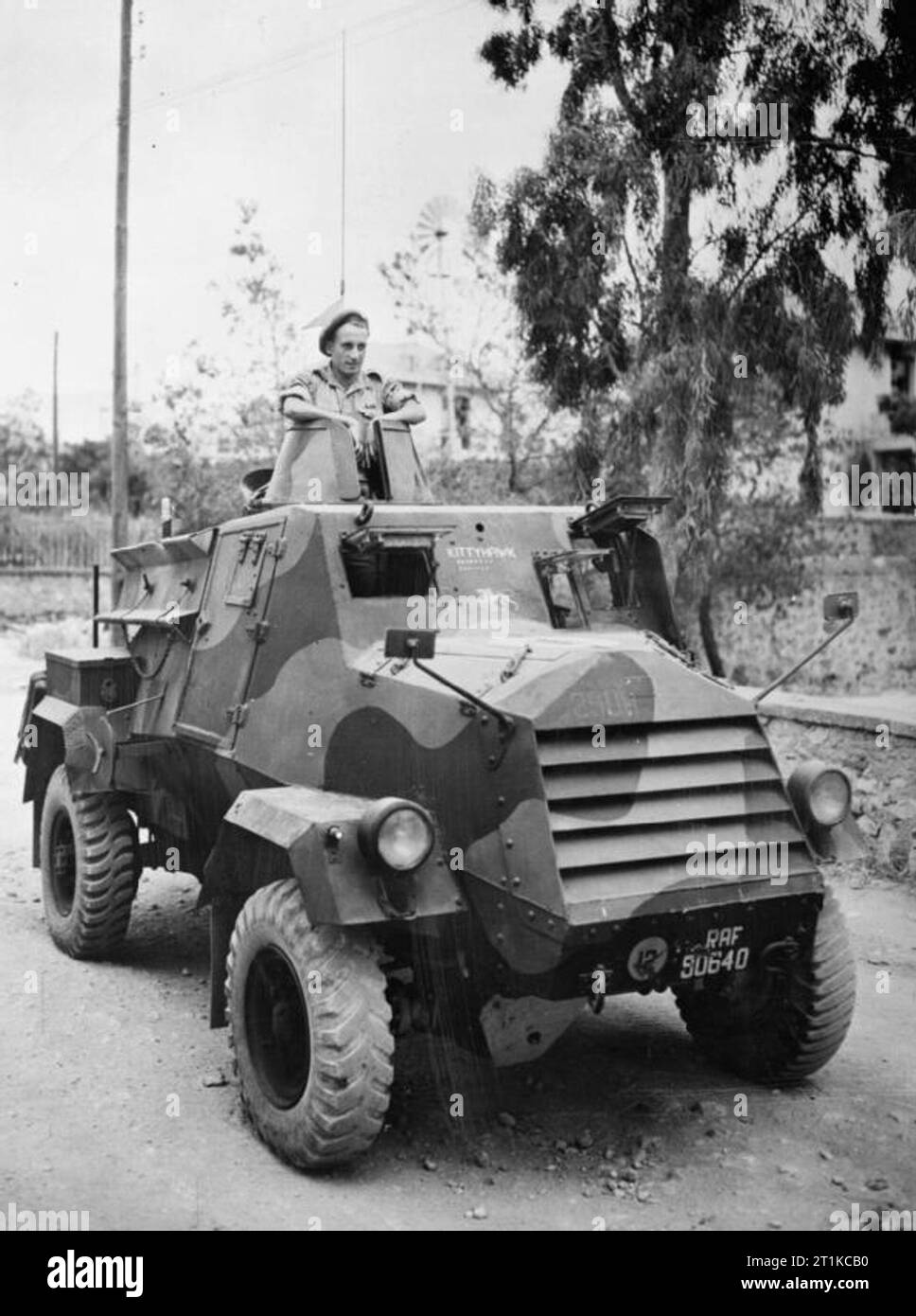 Royal Air Force- Italy, the Balkans and South-east Europe, 1942-1945. Sergeant G H Wingate of No. 2908 Field Squadron RAF Regiment sitting in the turret of an Otter light reconnaissance car in Athens, after being awarded the Military Medal for his actions during an engagement with German troops in northern Greece. On 28 October 1944, 2908 Squadron were pursuing retreating Germans to the Yugoslavian border. An armoured car driven by Sergeant (then Corporal) Wingate was reconnoitering enemy positions at Kozani when it came under fire from a 37mm anti-tank gun and received several direct hits, wo Stock Photo