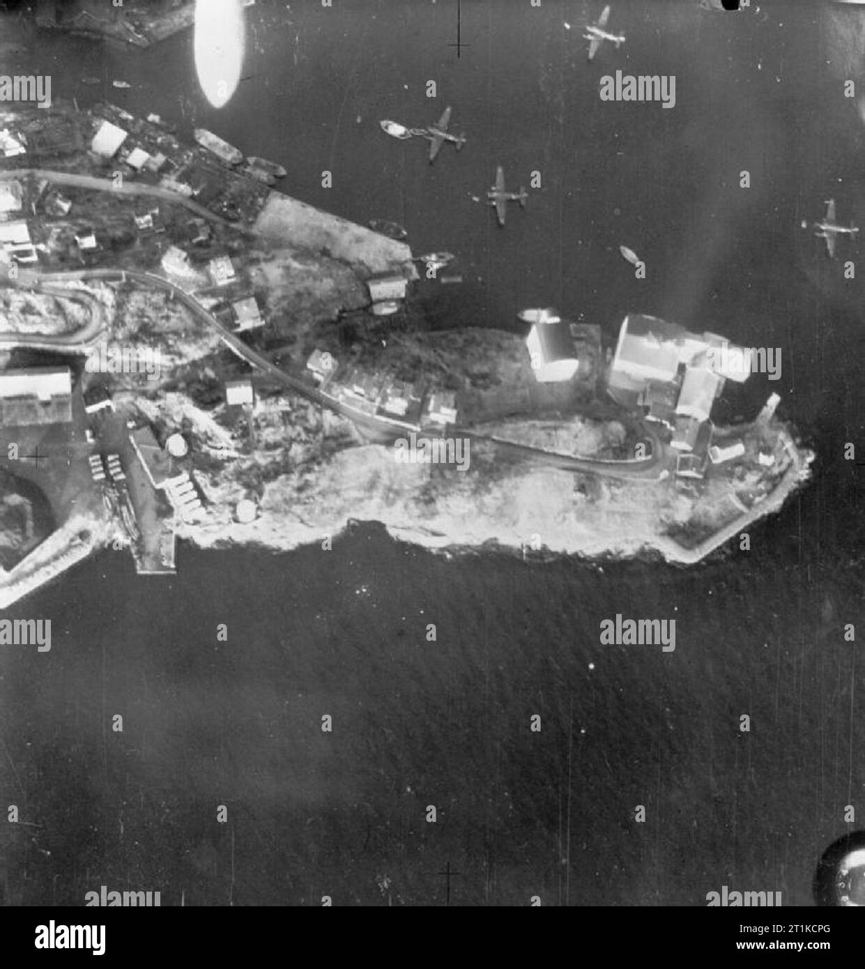 Royal Air Force- Operations Over Norway, April 1940. A bomb (upper left) dropped from an aircraft of Coastal Command, falls on Junkers Ju 52/See transport seaplanes of KGrzbV 108, moored in Bergen harbour. Stock Photo