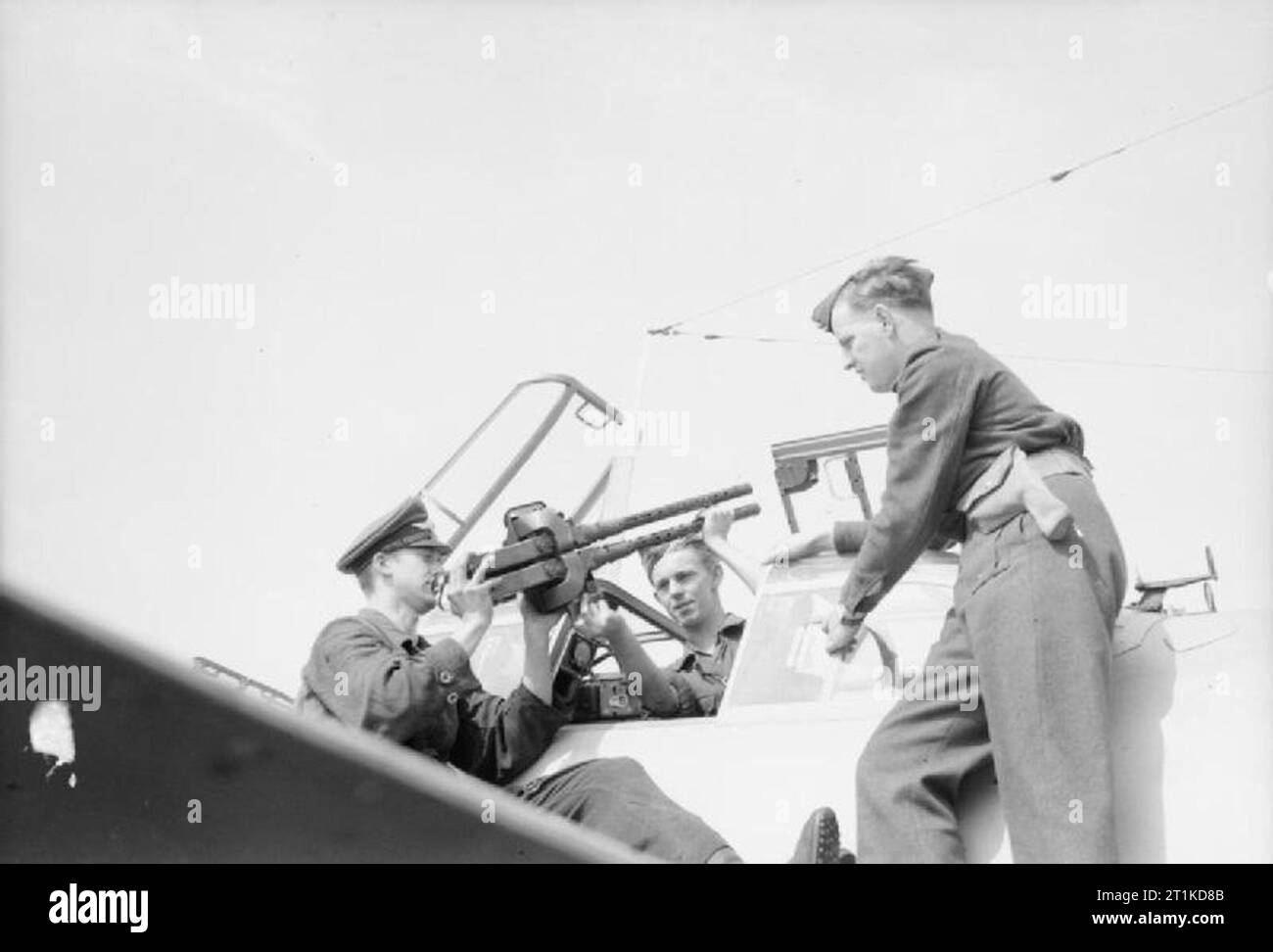 The Royal Air Force in Denmark Following the Liberation, 1945 German prisoners of war remove the machine guns from a Messerschmitt Bf 110G night fighter under the supervision of a Royal Air Force armament officer, 1945. Stock Photo
