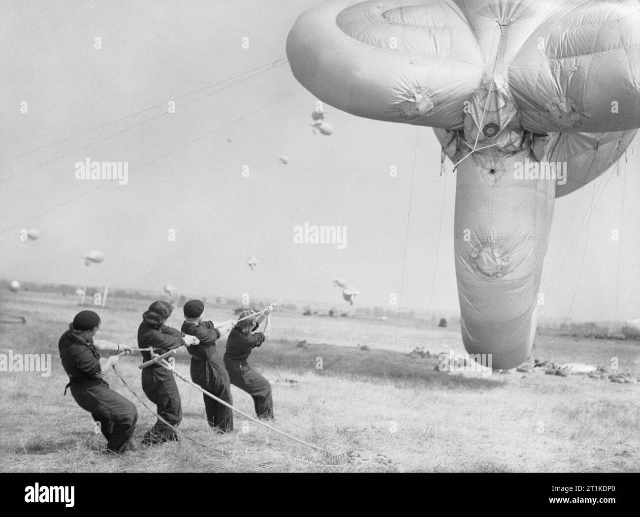 Women on the Home Front 1939 - 1945 The Women's Auxiliary Air Force (WAAF): Aircraftwomen learning how to handle a barrage balloon at the training station at Cardington. Stock Photo