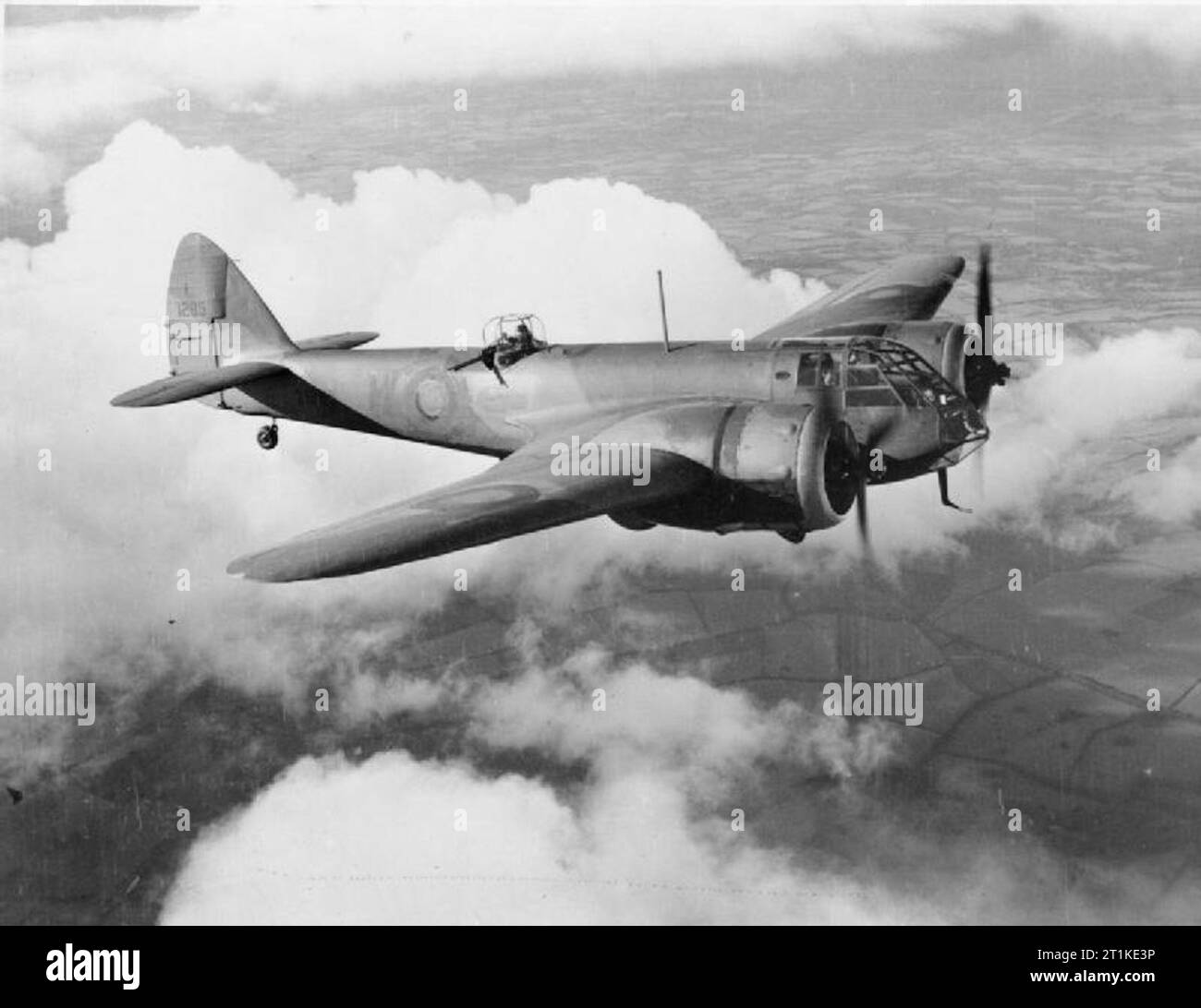 Aircraft Ofthe Royal Air Force, 1939-1941- Bristol Type 142m Blenheim I. Bristol Blenheim Mark I, L1295 in flight above the clouds. This aircraft commenced service in August 1938 with No. 107 Squadron RAF, followed by No. 600 Squadron RAF, the Royal Aircraft Establishment, No. 54 Operational Training Unit, RAF Cranwell, No. 3 Radio School, and finally No. 12 (Pilots) Advanced Flying Unit, with whom she was damaged beyond repair after crash-landing at Harlaxton on 29 July 1943. For reasons not known, the fuselage roundel and unit code were painted out at the time this photograph was taken. Stock Photo