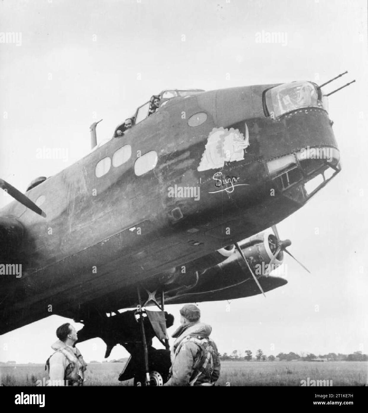 Aircrew and Nose art on 'S-Sugar', a Short Stirling of No. 7 Squadron RAF, in a dispersal at RAF Oakington, Cambridgeshire. Stock Photo