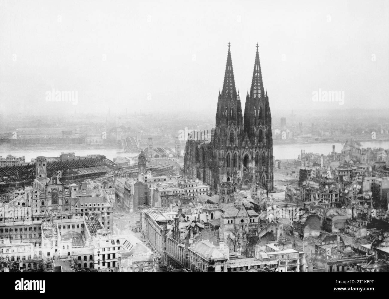Cologne Cathedral stands intact amidst the destruction caused by Allied air raids, 9 March 1945. Aerial oblique view of destroyed buildings in Cologne, Germany, caused by RAF Bomber Command raids on 9 March 1945. Stock Photo