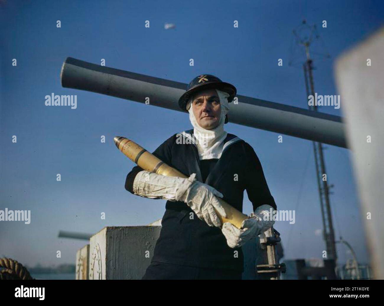 The Royal Navy, November 1943 A naval gunner, wearing antiflash gear holding a shell Stock