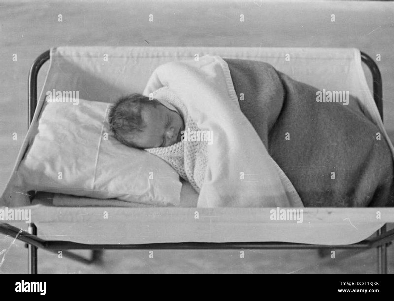 Day Nursery at Tottenham, London, England, 1940 A tiny baby sleeps in a