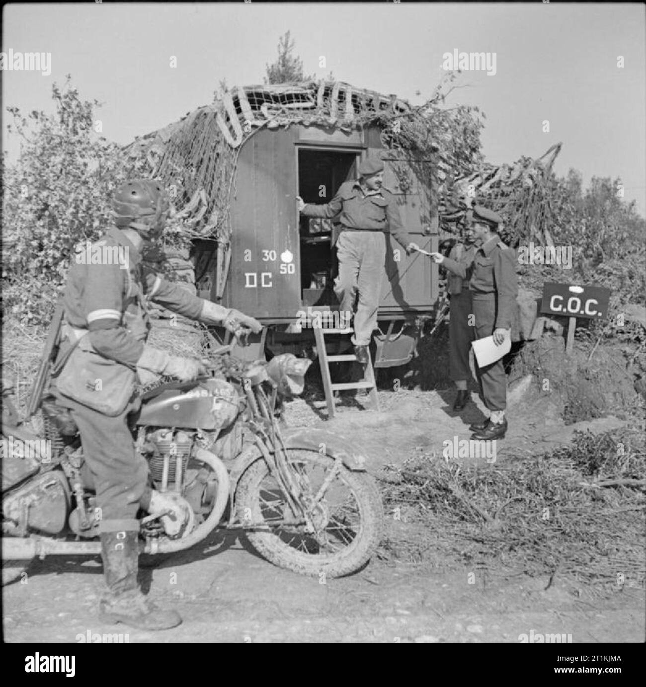 The British Army in Italy 1944 A motorcycle despatch rider watches as ...