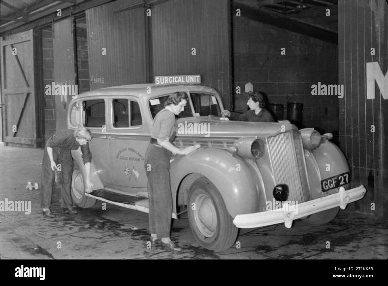 Flying Bomb- V1 Bomb Damage in London, England, UK, 1944 Women of the American Ambulance Great Britain wash an ambulance car of the surgical unit to pass the time between call-outs at their depot, somewhere in London. Stock Photo