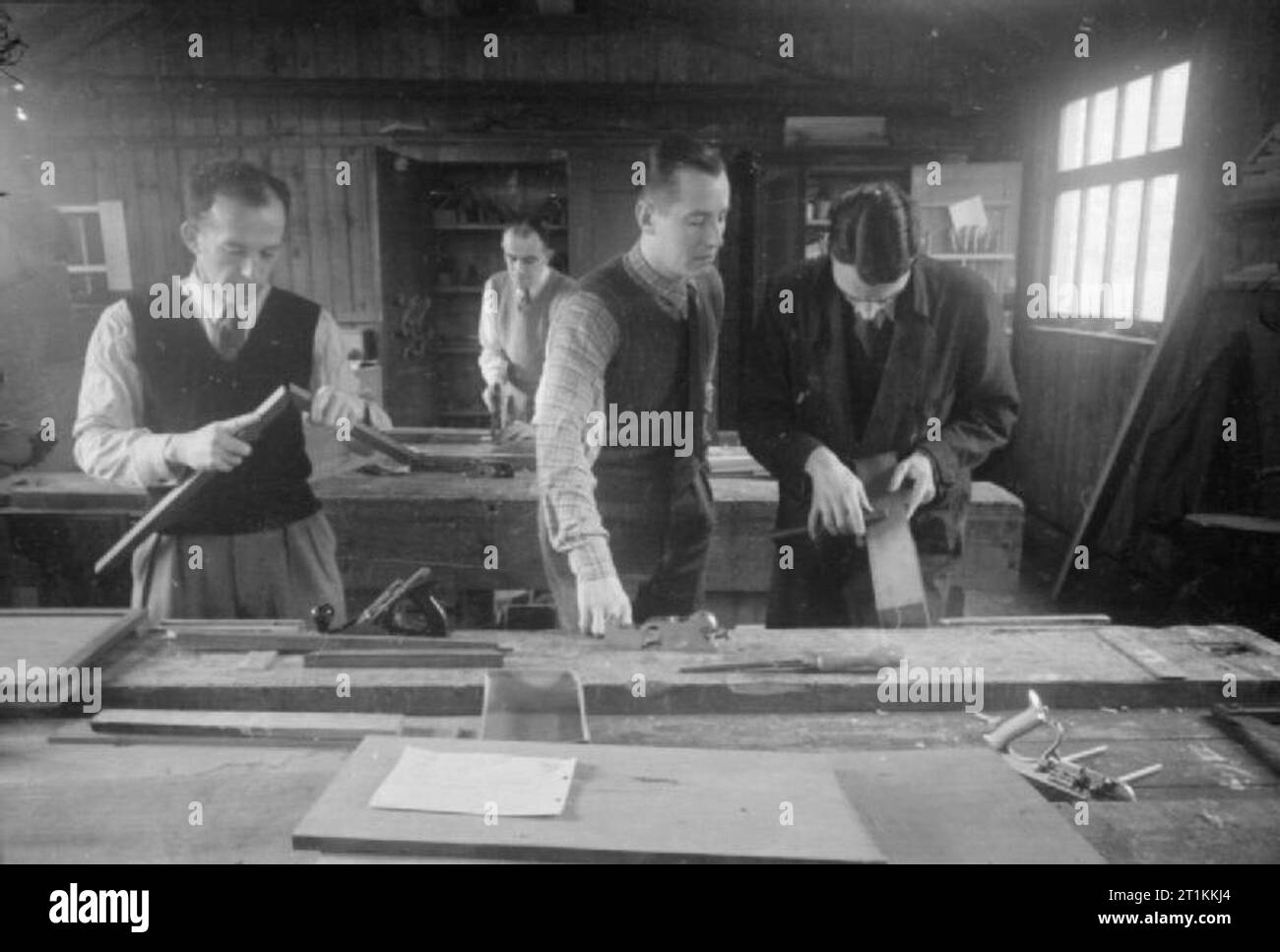 From the Services To Schoolmastering- Re-training at Goldsmith's College, London University, Nottingham, England, 1944 Ex-servicemen who are training to be handicraft teachers at Goldsmiths College (based at Nottingham University since the outbreak of war) take part in a lesson on woodwork and bookbinding. Stock Photo