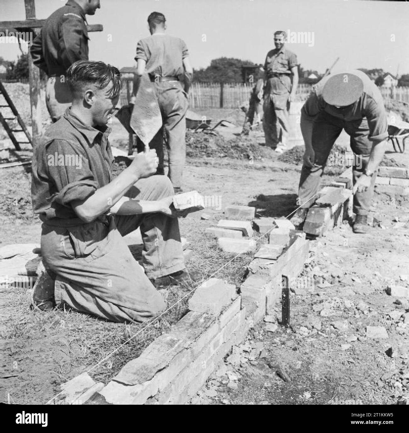 Grenadier Guardsmen Build Emergency Housing in Windsor Guardsmen laying