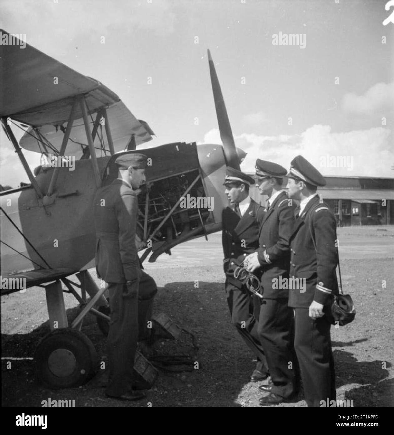 Persian Airmen Train in Britain, 1944 Three Persian airmen chat to a member of the Royal Air Force beside an aircraft. The Persian men are Lieutenant Mohamad Khatami from Rasht, Lieutenant Ahmed-Ali Jahanbin from Tehran and Lieutenant Nasrollah Shahrokay, also from Tehran. According to the original caption, Lt Shahrokay's father is Iranian Minister in Moscow. Stock Photo