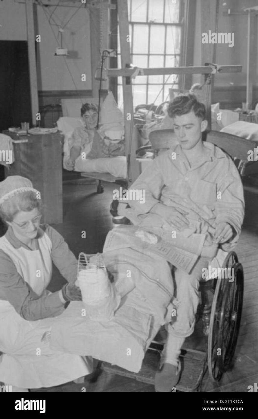 The work of the American Hospital in Britain, Park Prewett Hospital, Basingstoke, Hampshire, February 1941 Sister Alma Gee dresses the injured foot of a man who was wounded by a High Explosive at Park Prewett Hospital in Basingstoke in February 1941. Stock Photo