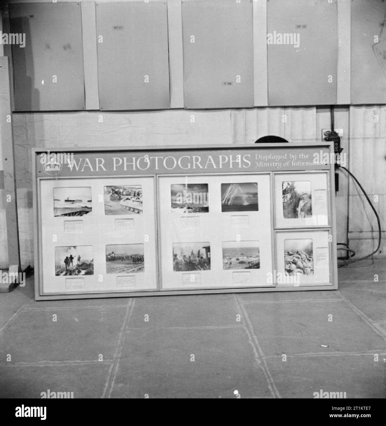 The work of the Ministry of Information during the Second World War, UK, 1942 A view of a 'topical screen', featuring ten war photographs taken by official photographers and displayed by the Ministry of Information. This photograph was taken at MoI headquarters at Senate House, London. Stock Photo