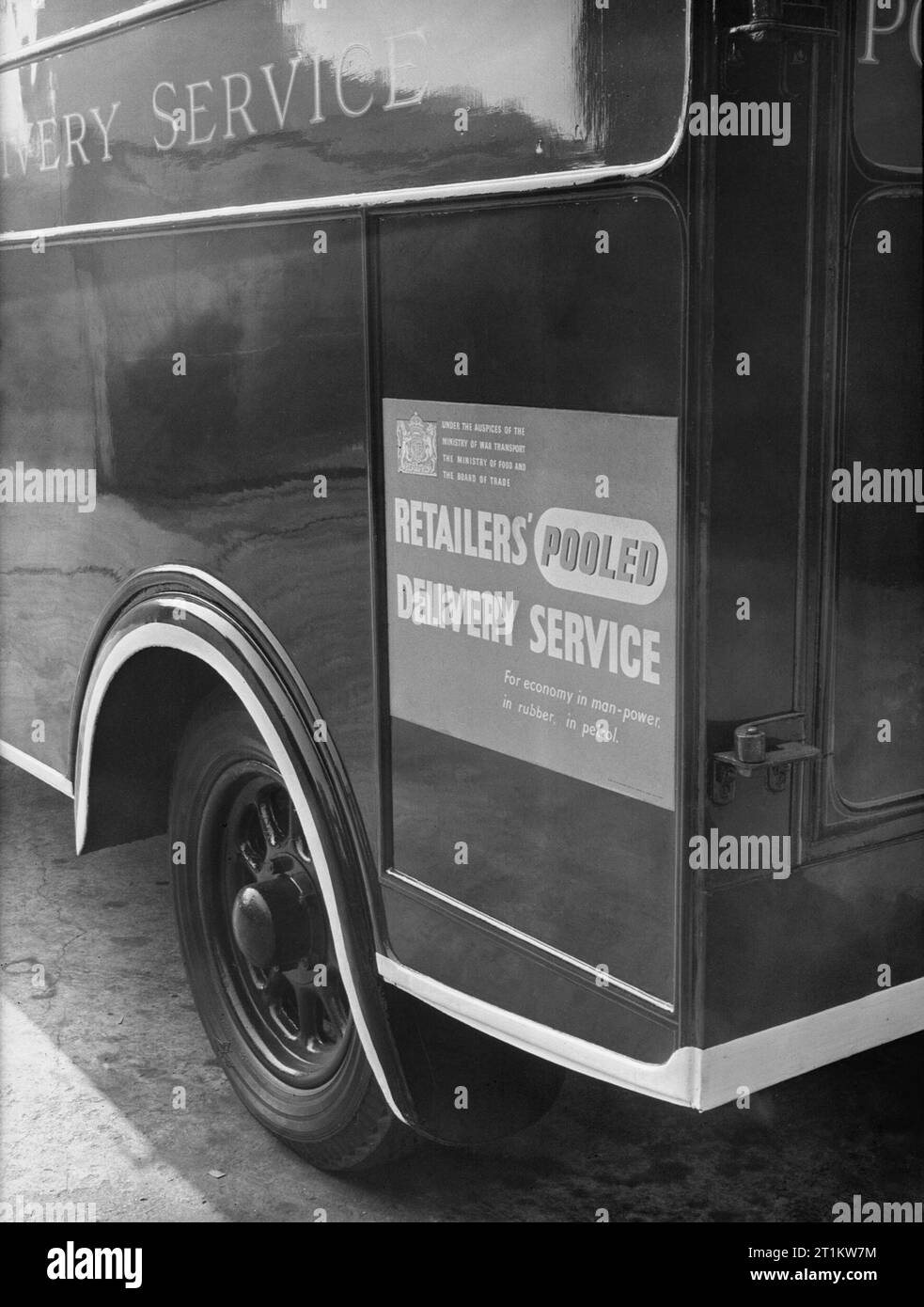 Wartime Fuel Economy- Pooled Delivery Service Van, 1942 A close up of the back of a van showing the sticker which reads 'Under the auspices of the Ministry of War Transport, the Ministry of Food and the Board of Trade. Retailers' Pooled Delivery Service. For economy in man-power, in rubber, in petrol'. Stock Photo