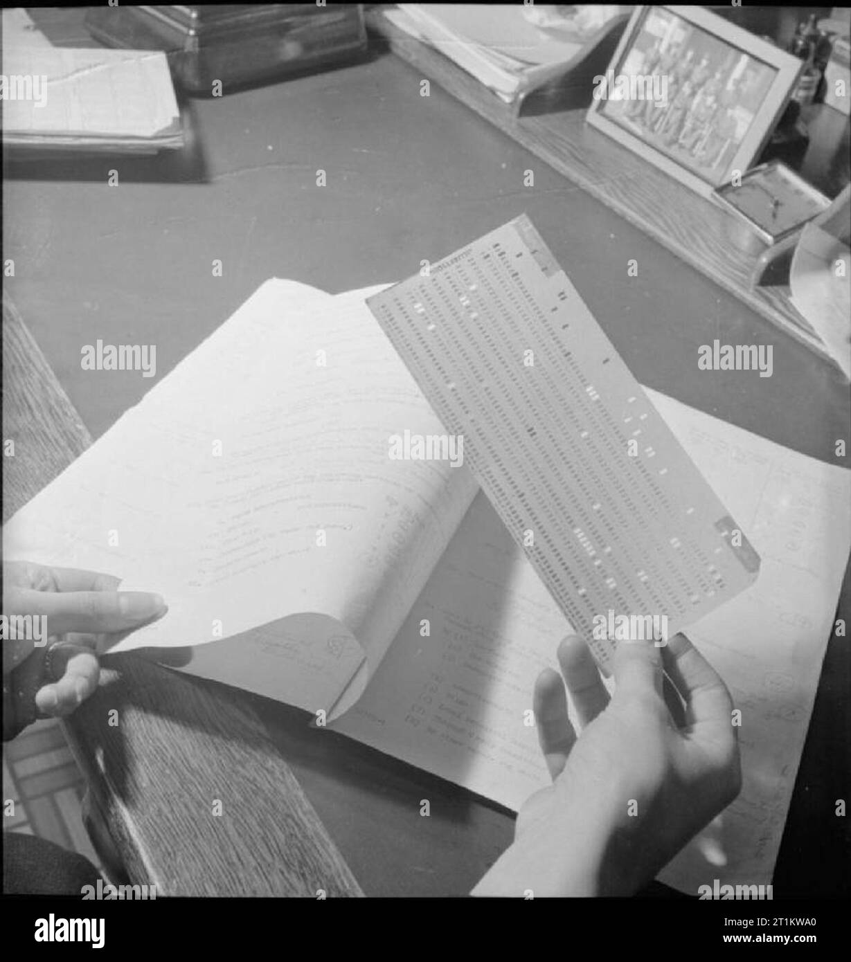 Wartime Social Survey- Information Gathering in Wartime Britain, UK, 1944 The information which has been gathered by interviewers arrives at the Wartime Social Survey as a series of ringed answers to questions on questionnaires. These answers are given code numbers which are then transferred to punched cards, with each hole representing the code number for a particular answer. Stock Photo