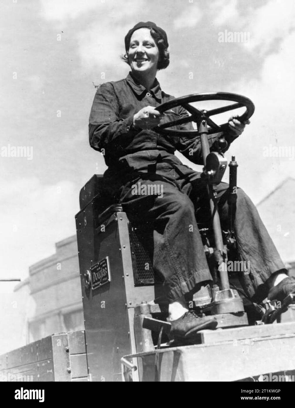 Women's War Work- Life in a Shell Factory, England, UK, 1942 Mrs C Gunnee of 3 Victoria Terrace, Broomhill, Sheffield drives a Douglas forklift truck at a shell factory somewhere in Yorkshire. She has two children and her husband is also a munitions worker. Stock Photo