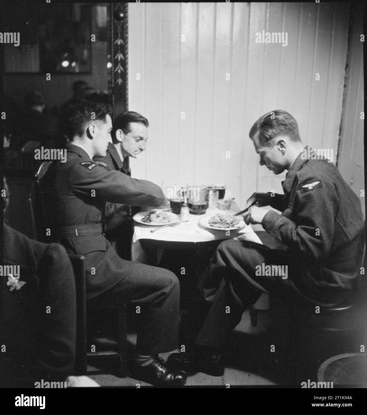 Belgian Clubs and Cafes in London- Rest, Relaxation and Entertainment, London, England, UK, 1945 Three Belgian airmen enjoy a meal at a London restaurant called 'Chez Rose'. Stock Photo