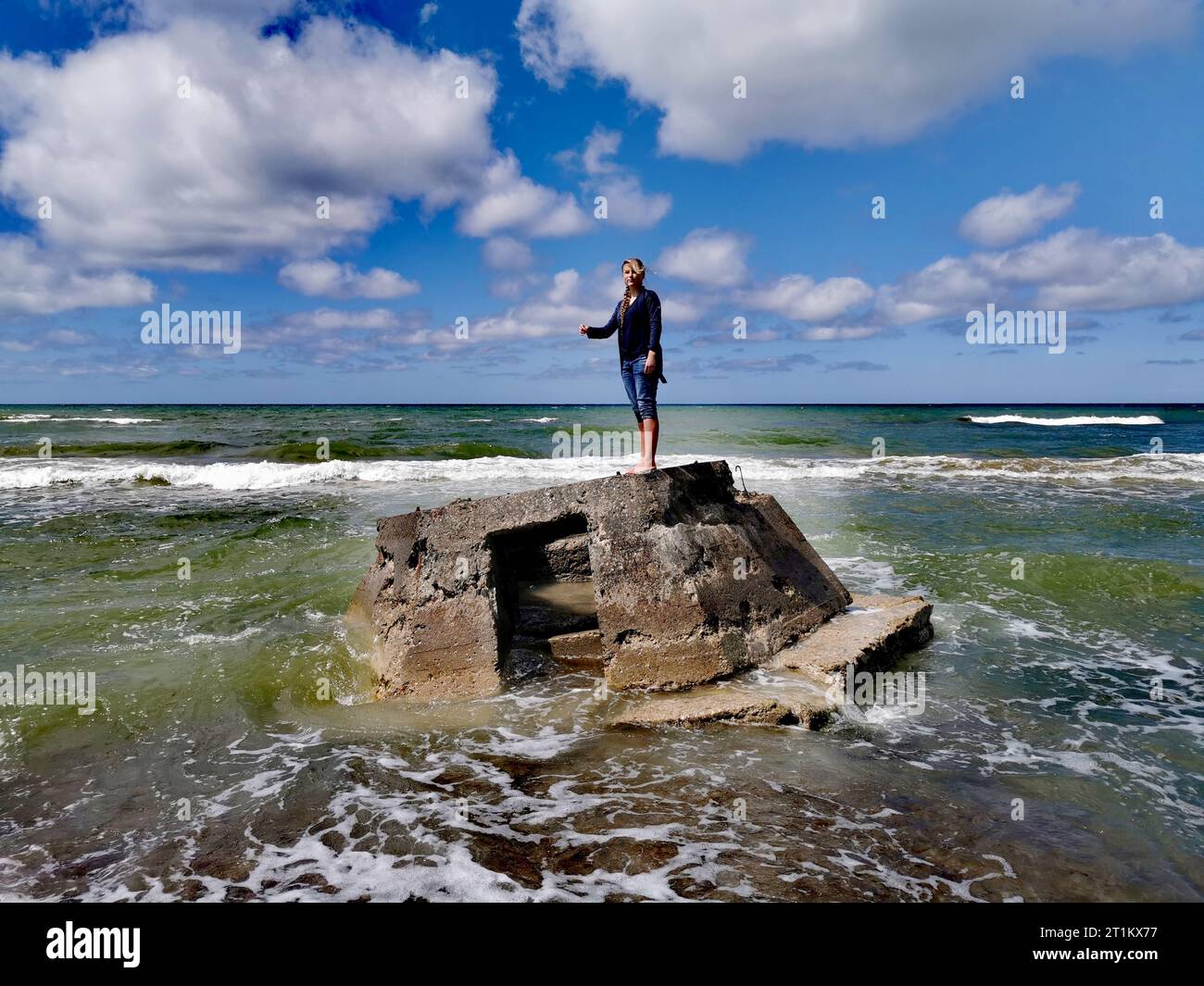 Scenic Portrait: Waves and clouds conductor. Portrait in landscape. Seaside Stock Photo