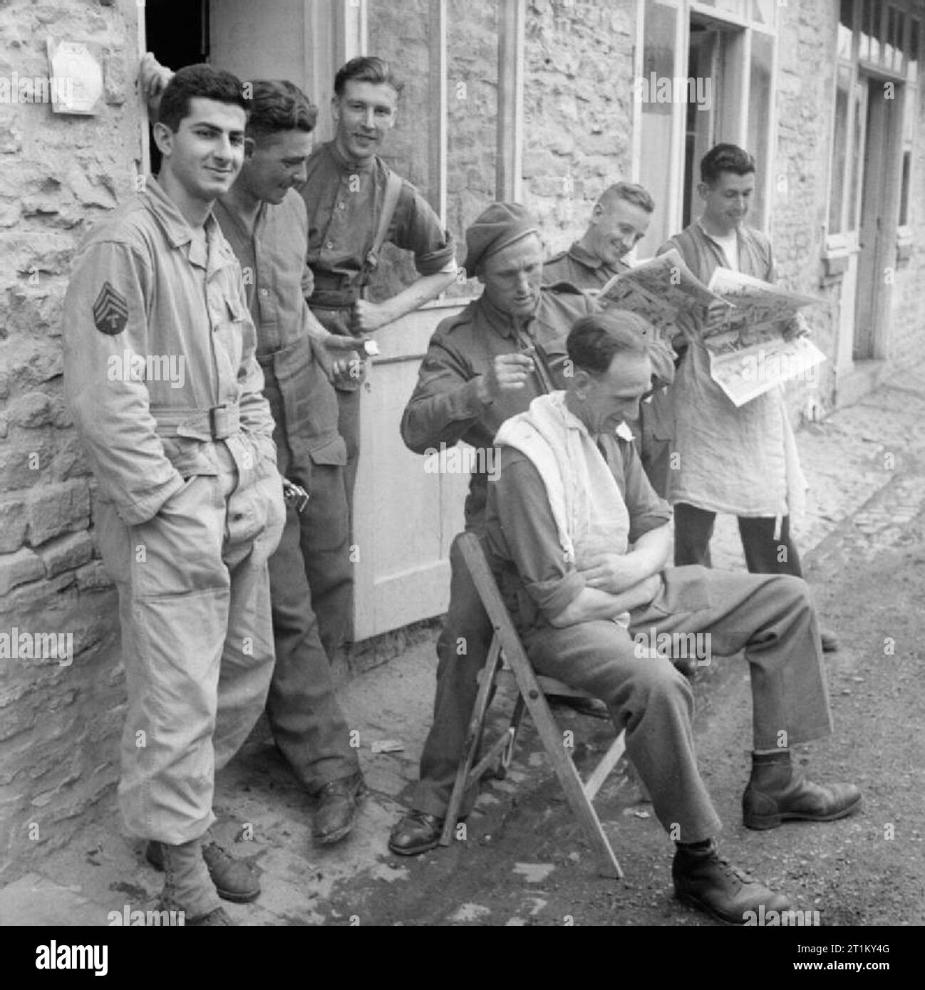 The British Army in Normandy 1944 British and American troops queue to