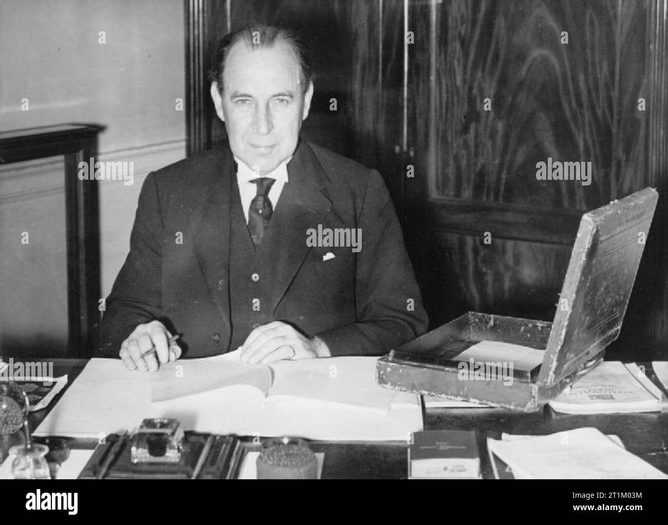 British Political Personalities 1936-1945 The Churchill Coalition Government 11 May 1940 - 23 May 1945: Sir John Anderson, the Chancellor of the Exchequer, seated at his desk at the Treasury, the day before he presented the budget. Stock Photo