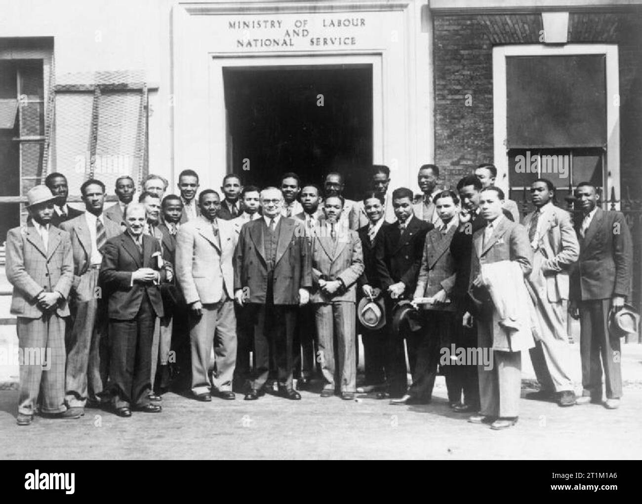 West Indians in Britain during the Second World War West Indian Labour Force in Britain: Skilled engineers, boiler makers and motor mechanics, all from the West Indies being welcomed at the Ministry of Labour, St James' Square, London. Learie Constantine, the famous cricketer from Trinidad who was employed as a Welfare Officer for West Indians working in Britain, introduces the men to the Minister of Labour, Ernest Bevin. Stock Photo