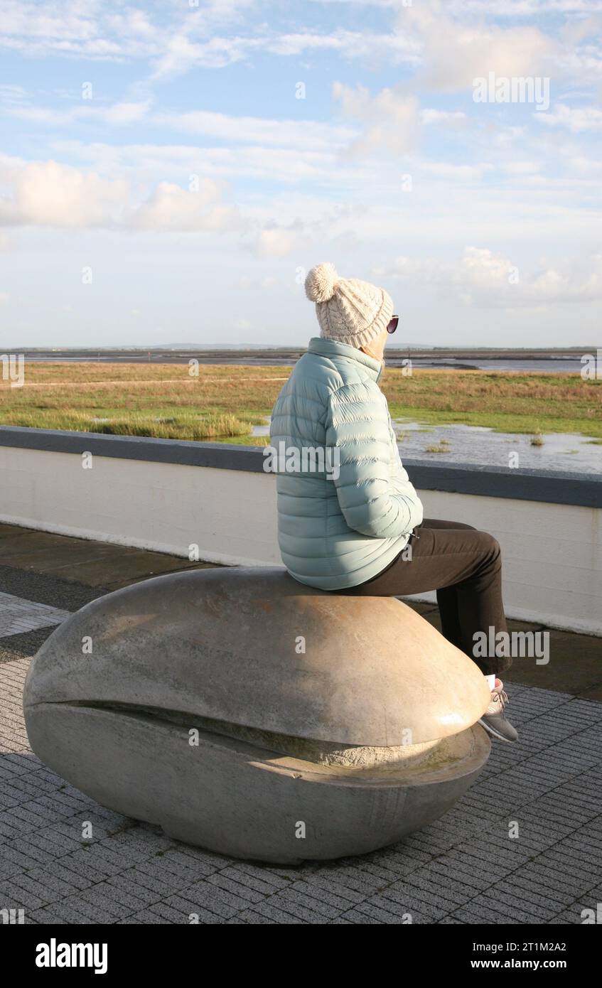 A lady looks out to sea from the Mussel Tank at Lytham St Annes, Lancashire, United Kingdom, Europe Stock Photo