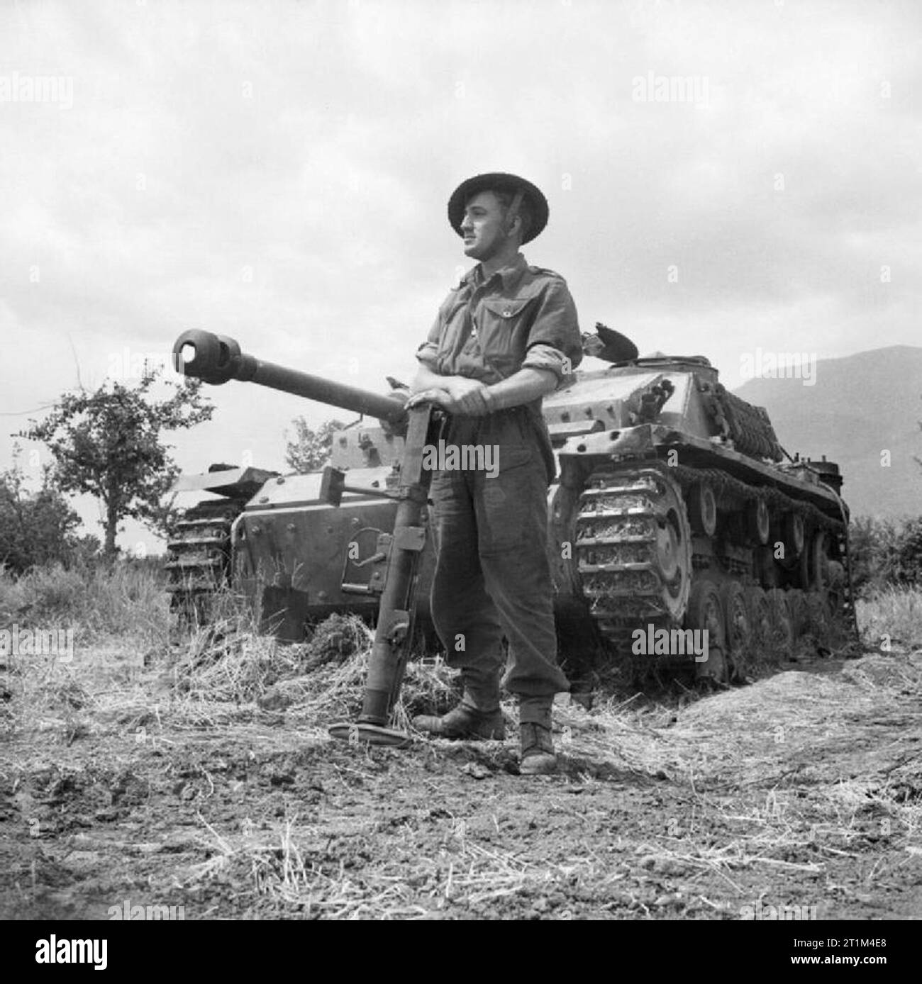 Fusilier Jefferson of 'C' Company, 2nd Lancashire Fusiliers, in front of a German StuG III assault gun which he knocked out with a PIAT, May 1944. Fusilier F Jefferson of 'C' Company, 2nd Lancashire Fusiliers in front of a German StuG III assault gun which he knocked out with a PIAT, May 1944. Stock Photo