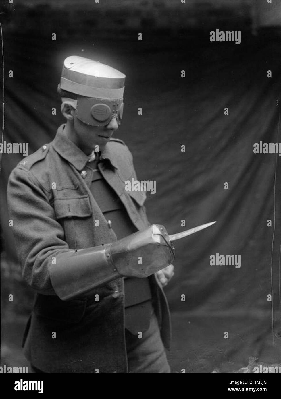 Ministry of Information First World War Official Collection Steel cap for wearing under ordinance cap, French splinter gogggles (vision is obtained through thin slits in goggles). And steel dagger gauntlet. Stock Photo