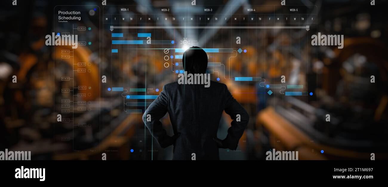 Back view of Engineer manager working with Ai computer virtual on The robotics schedule production plant is working on time. Stock Photo