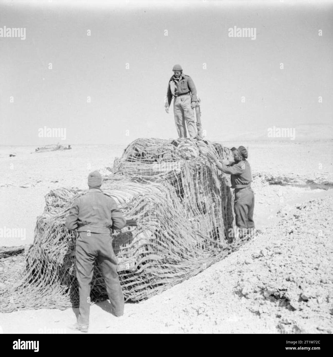 The British Army in North Africa 1942 Men of the Long Range Desert Group camouflage their vehicle to prevent detection from the air, 25 May 1942. Stock Photo