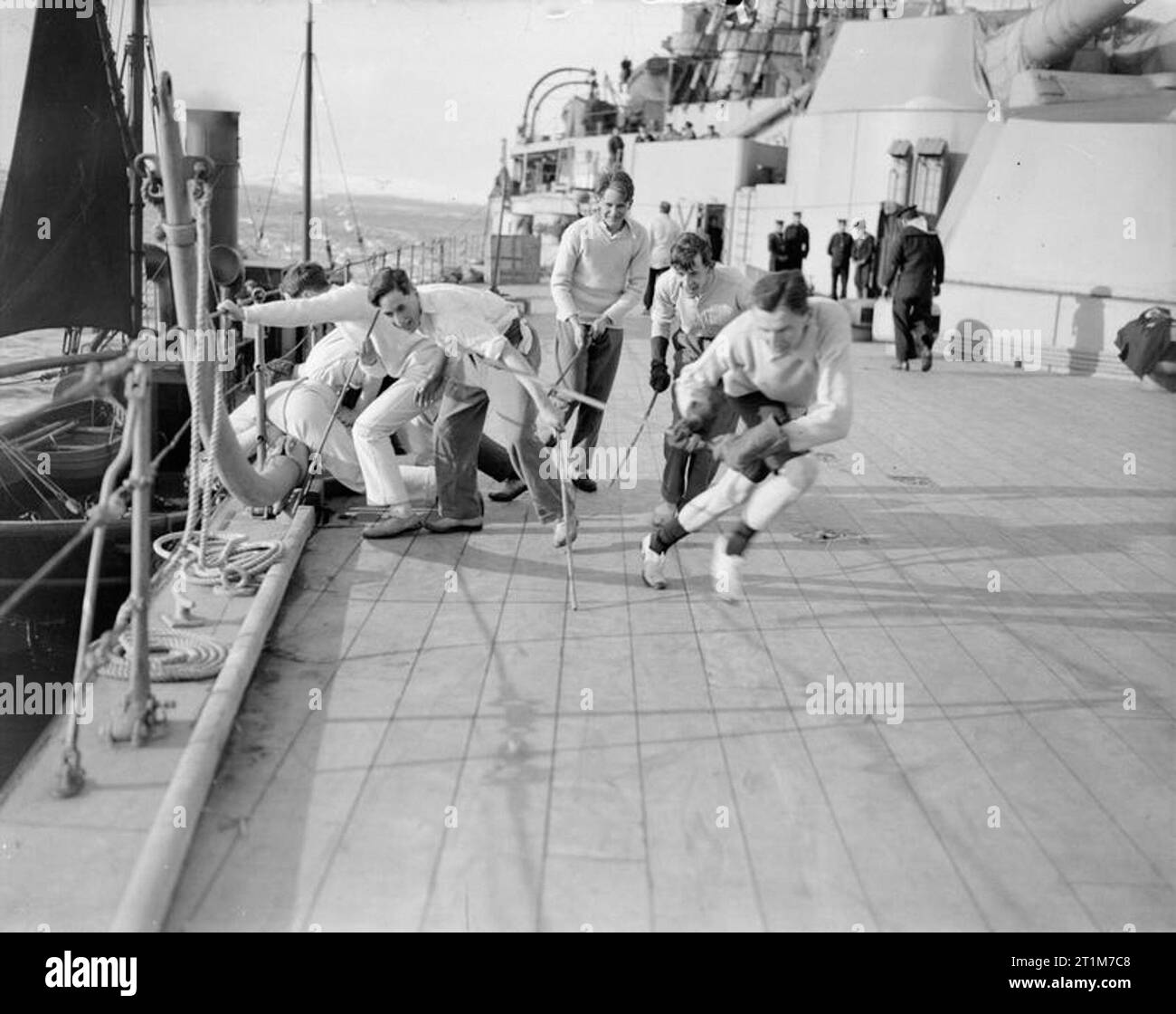 Official First World War Photographers Naval Official: Relaxation on board ship; officers playing hockey on the quarter deck of a battleship. Stock Photo